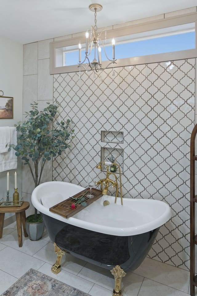 Sophisticated clawfoot tub under a statement chandelier, creating a serene and elegant space to unwind
