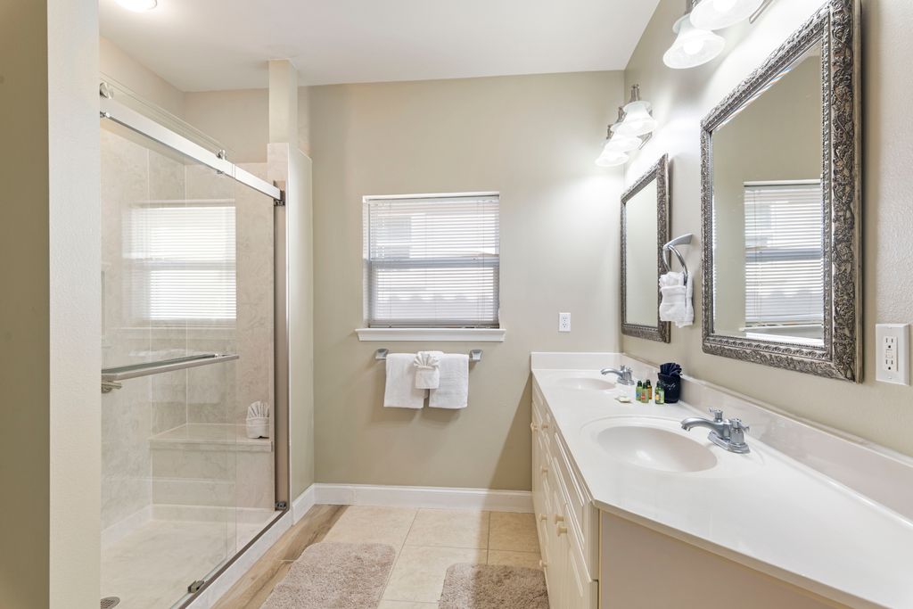 Second Floor: Bathroom 4– Modern, newly renovated bathroom with walk-in shower, sleek vanity, mirror, and beautiful lighting.