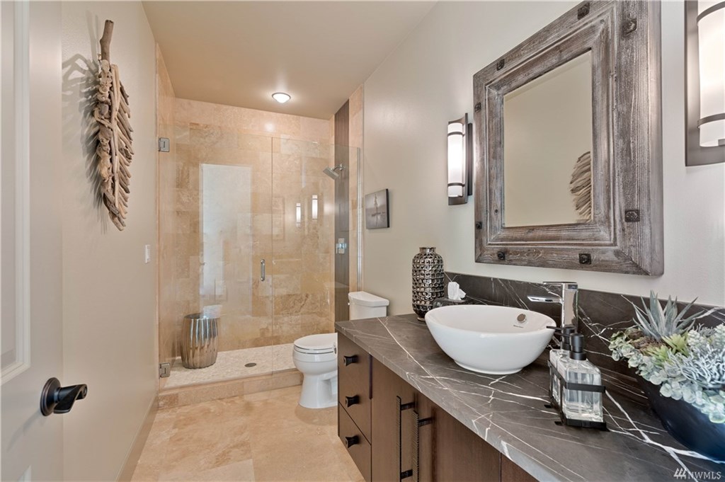 Downstairs bathroom featuring a vessel sink and walk-in shower.