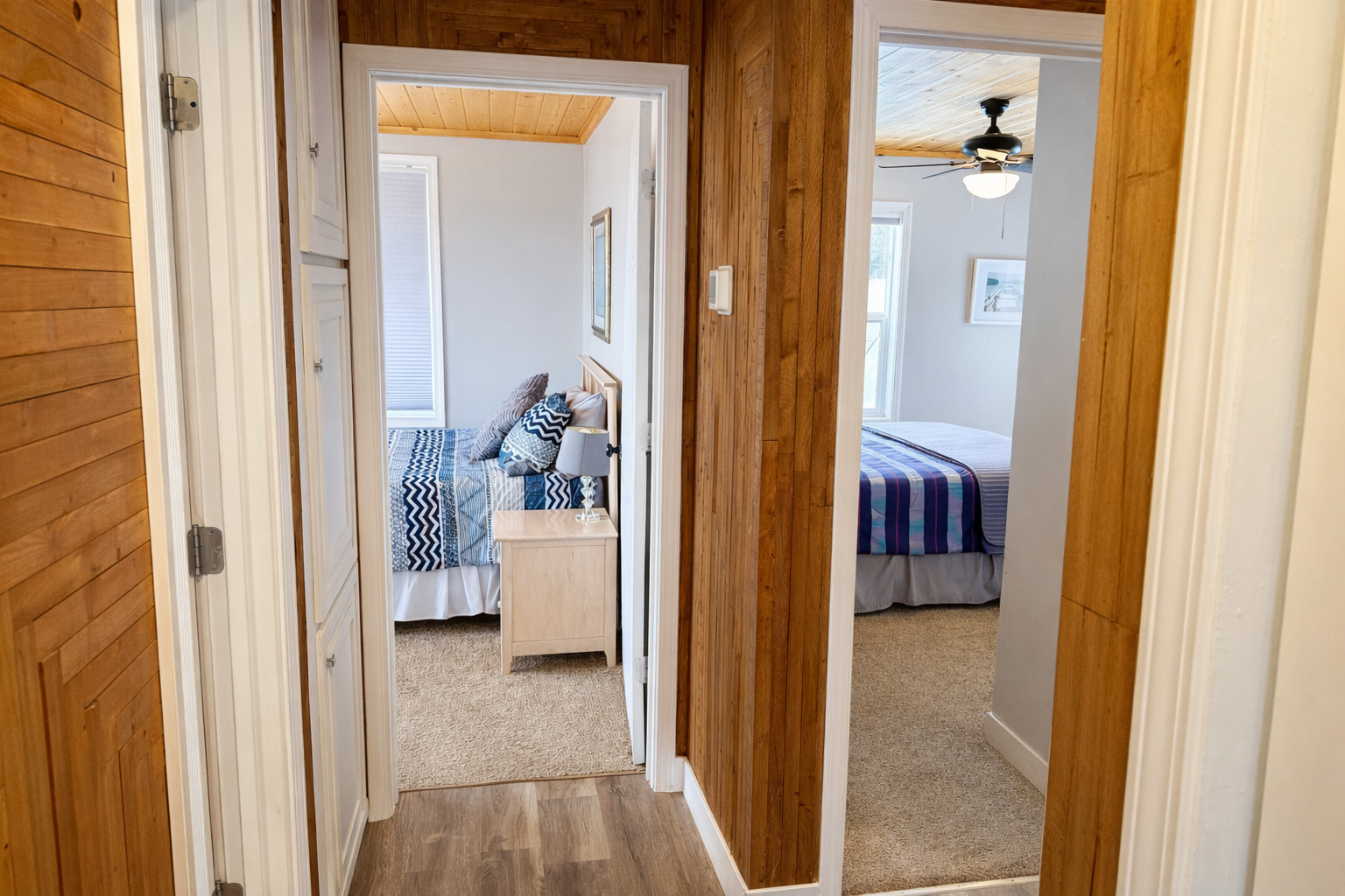 Just outside the bathroom, you’ll find the two main floor bedrooms conveniently close, making everything easily accessible. With a seamless flow from the bathroom to the sleeping spaces, guests enjoy this practical layout. 