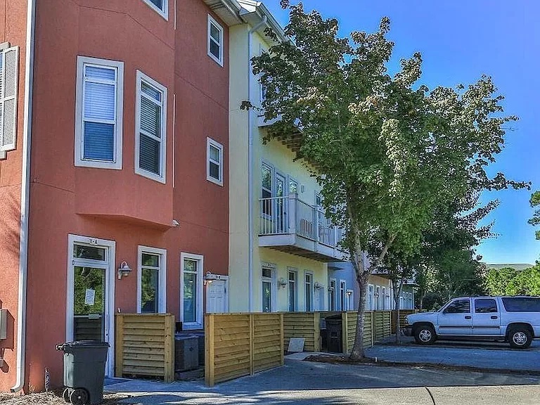 Two parking spots on the back side of the building, where you enter into the three-story walk-up