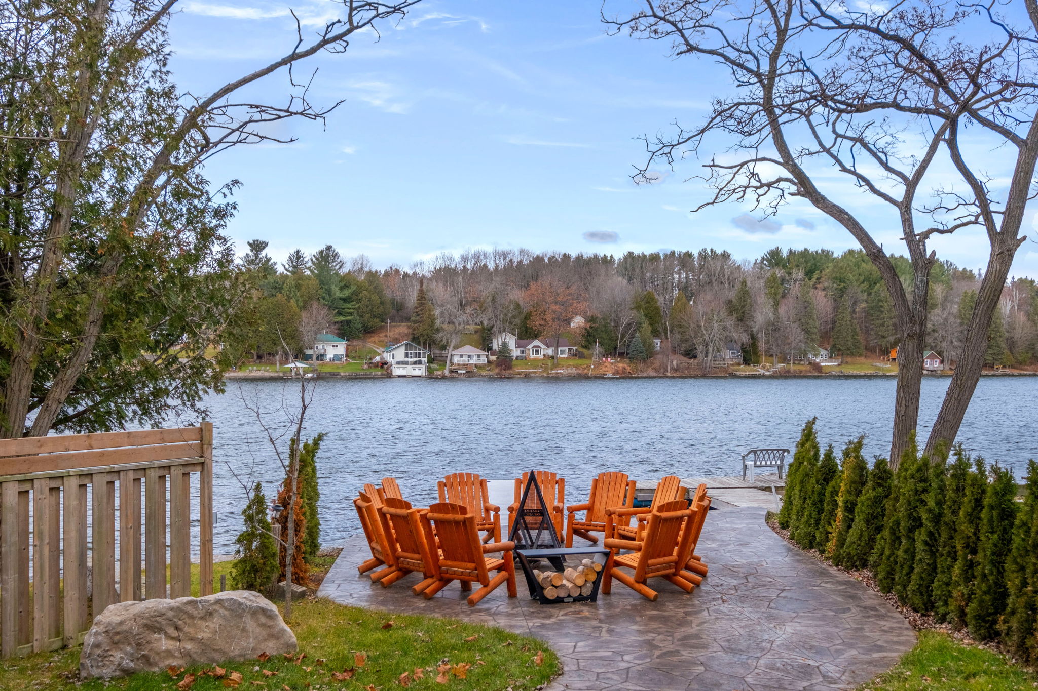 Lakeside gathering area with twelve Adirondack chairs — ideal for morning coffee or evening s’mores.