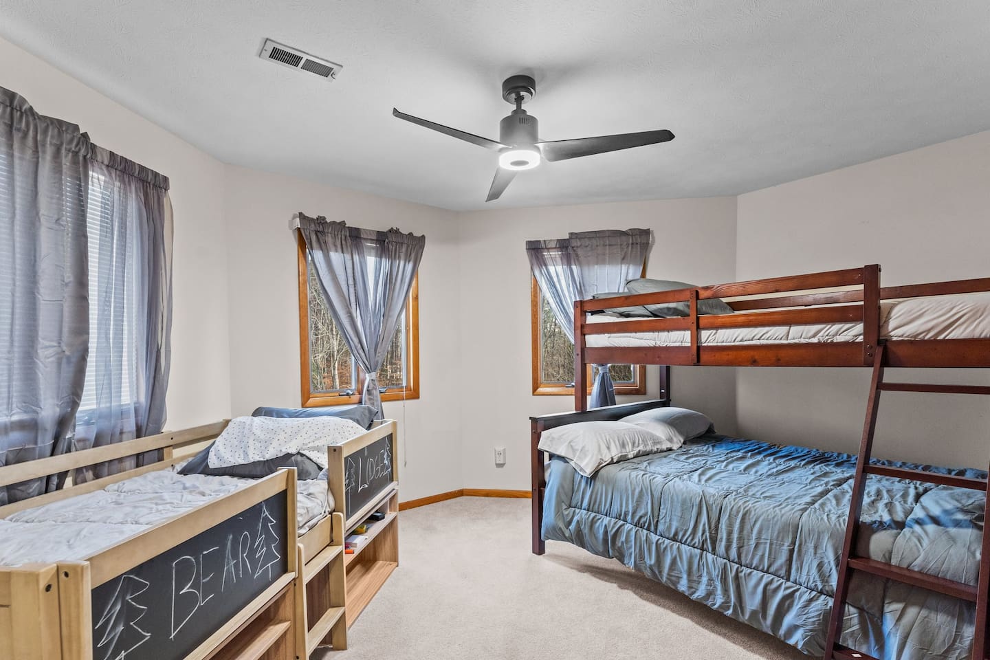Bunk Bedroom 3: Perfect for kids' adventures with playful beds and nature views just outside!