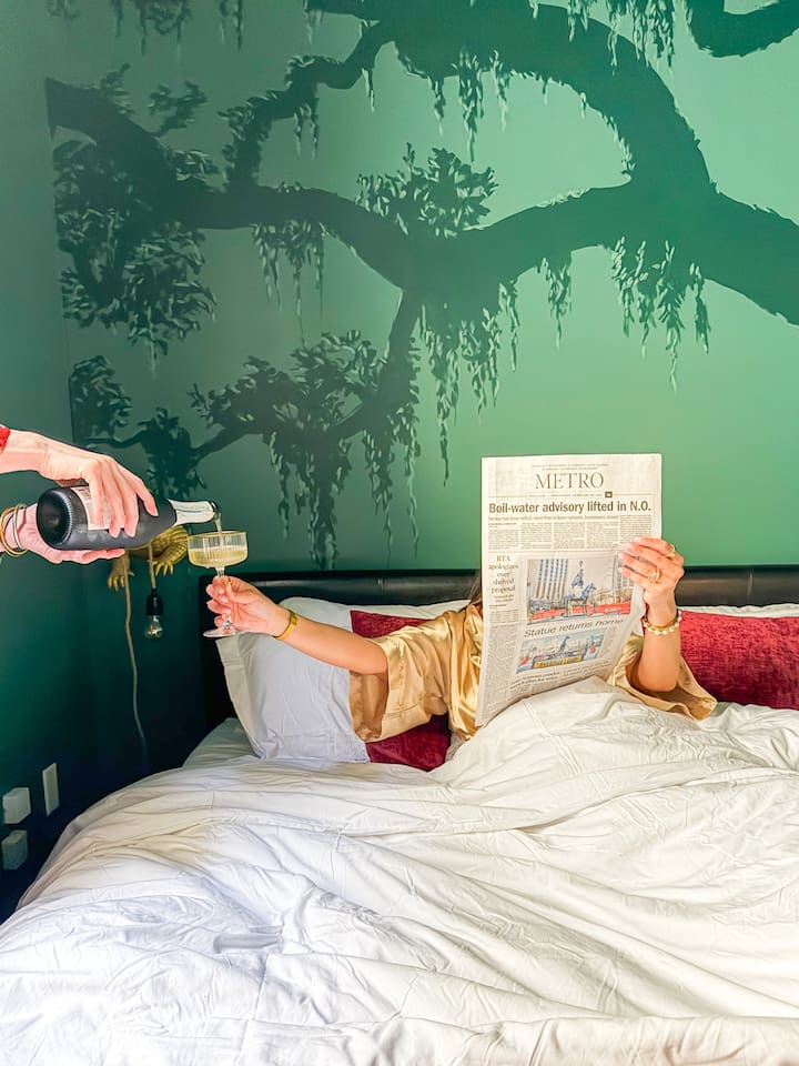 Why not? Champagne, the morning paper, and nowhere to be. Linger in the king bed beneath a dramatic southern oak mural, moss-draped walls & a starlit ceiling. NOLA mornings were made for this.