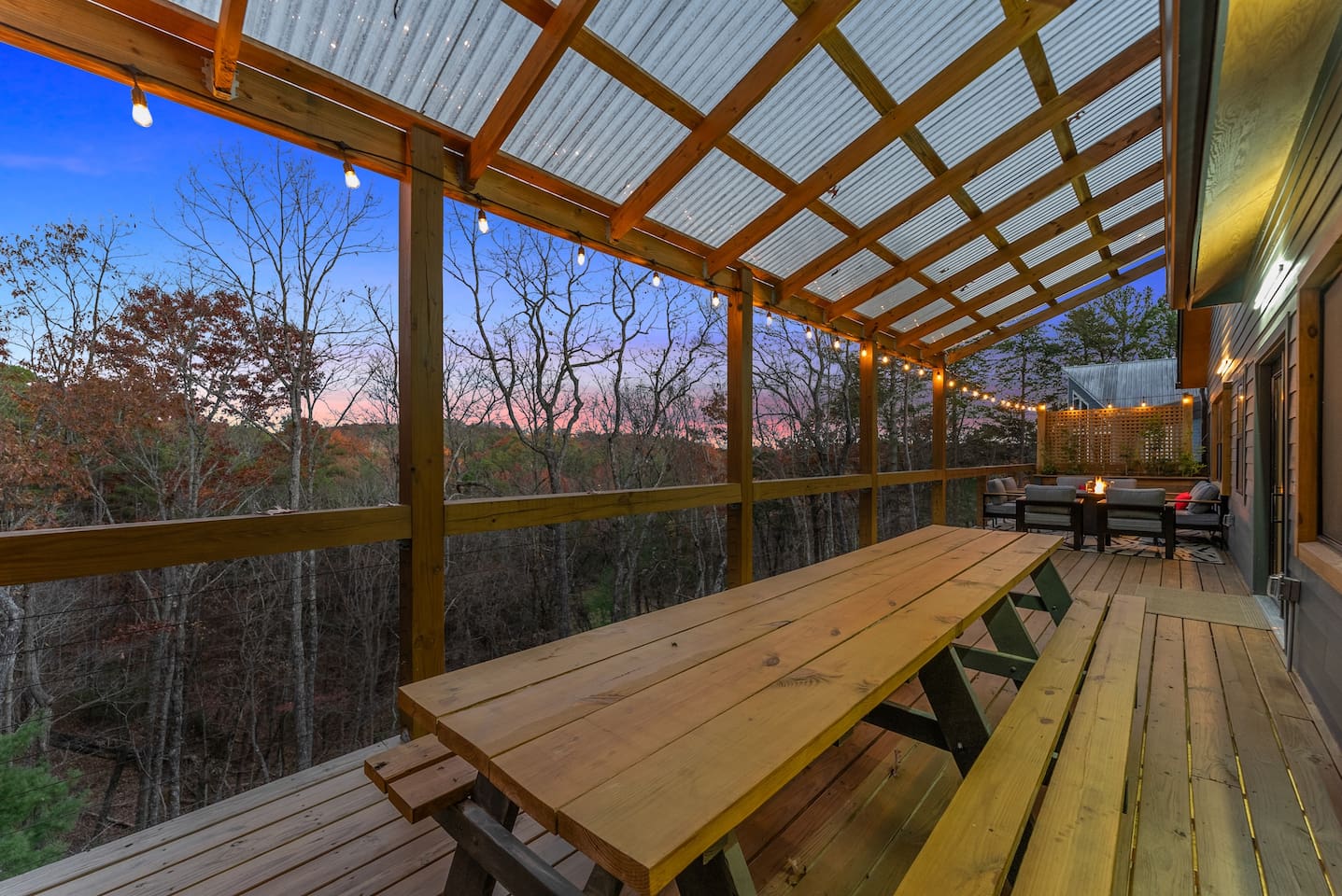 Dine under the twilight sky at the large outdoor table—perfect for enjoying sunset views and memorable meals.