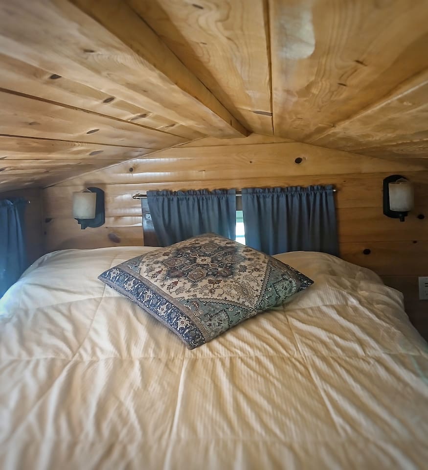 A comfy queen bed is in the loft! Access is a steep staircase made of shelves. Not recommended for those with mobility issues. 