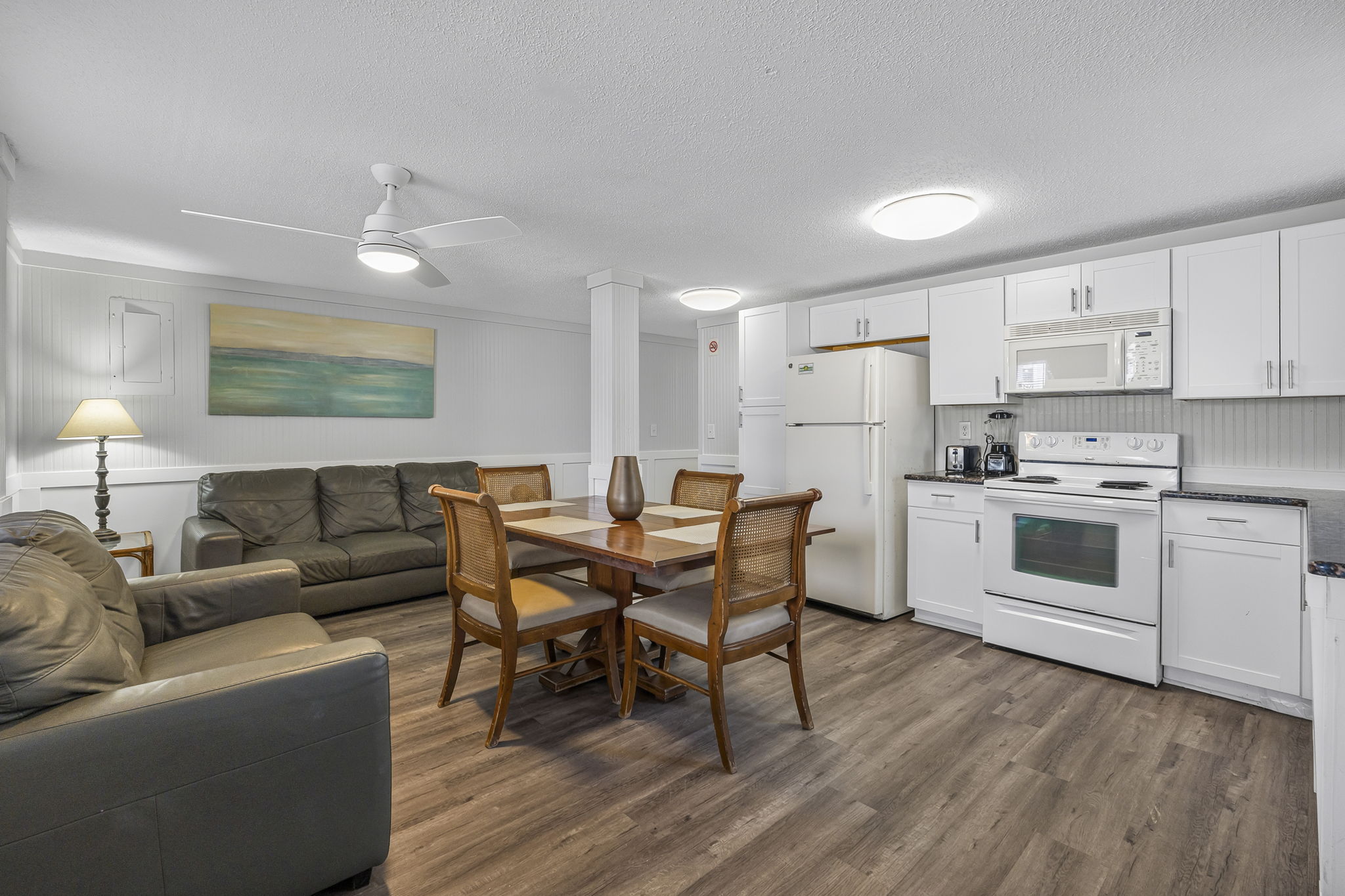 Full kitchen in Unit 2 with Dining room table and Smart TV