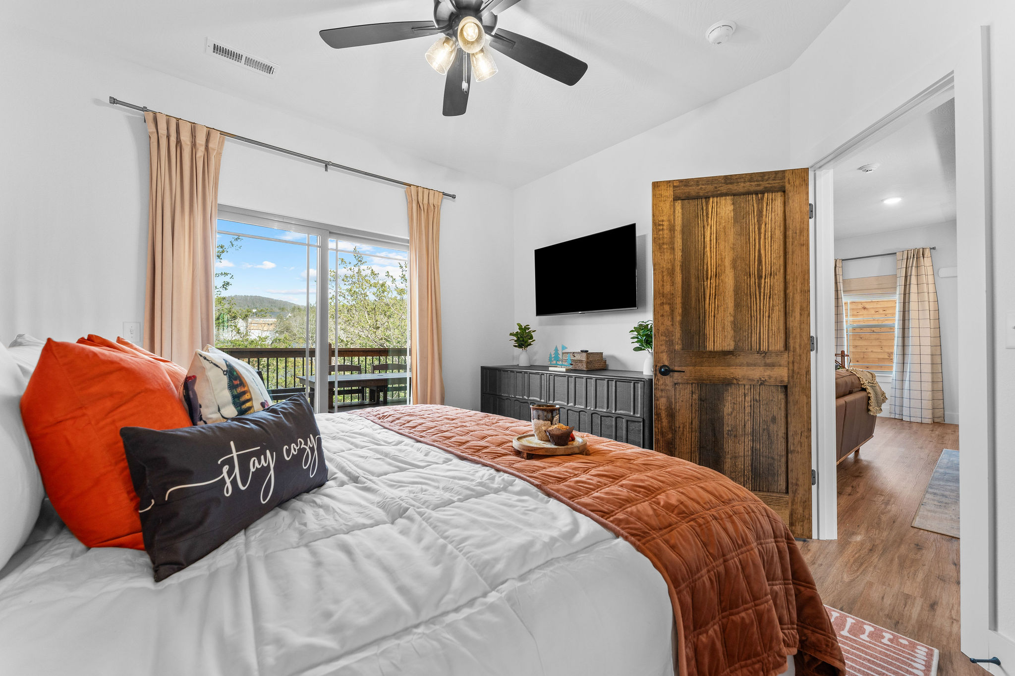 The fishing bedroom on the main level has a large dresser, smart TV and a great sunrise view to the East.