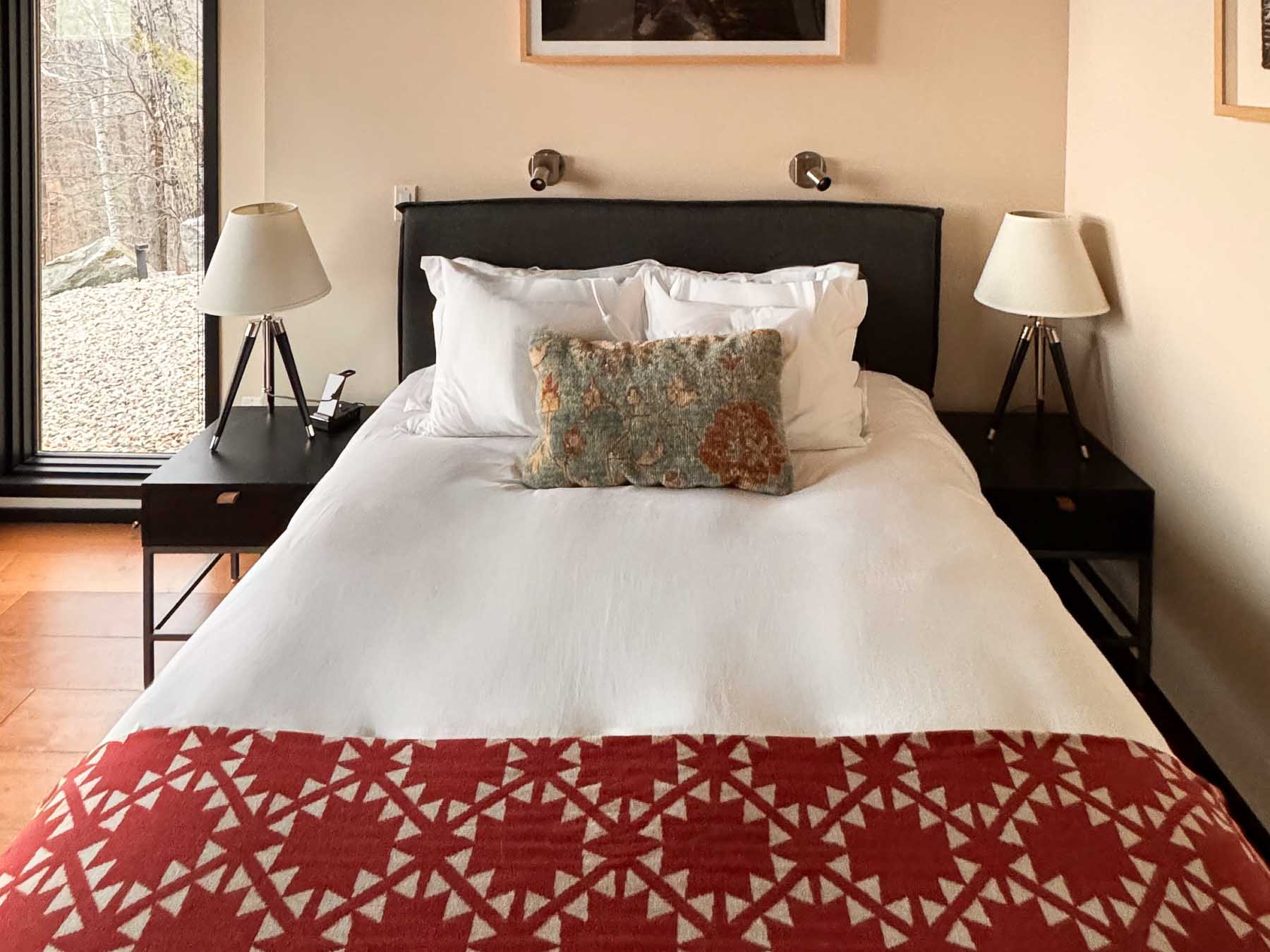 Bedroom Four at Sunset Falls &mdash; queen bed, framed forest photographs, ground floor terrace room