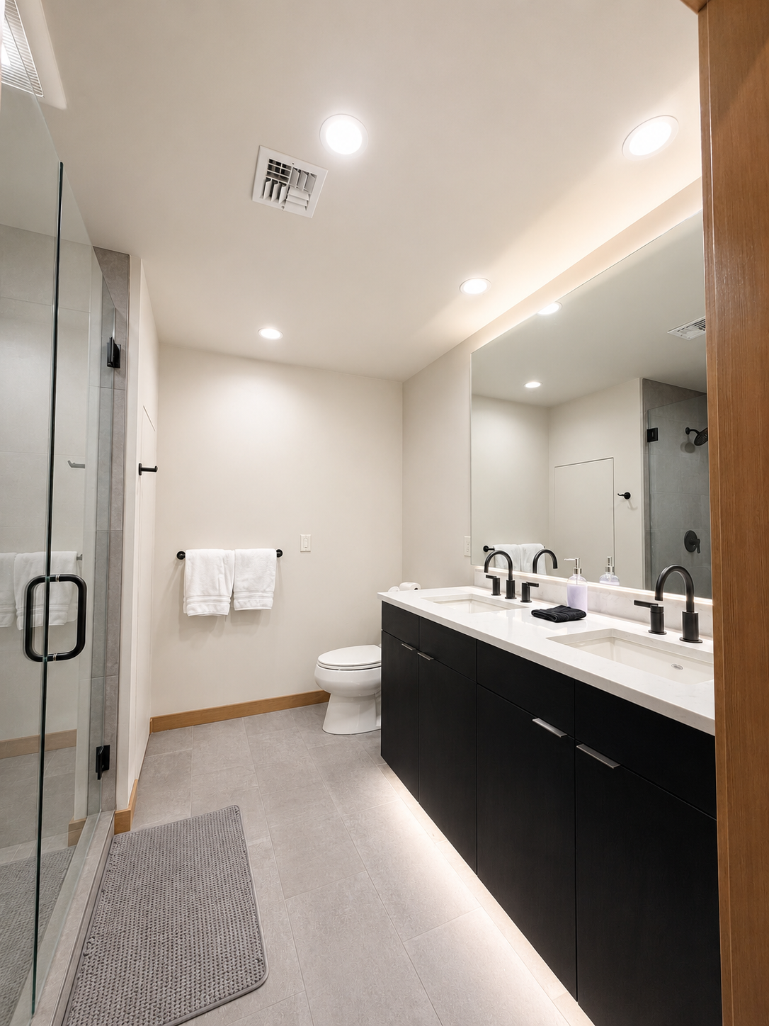 Spa-inspired bathroom featuring a dual-sink vanity, quartz countertops, matte black fixtures.