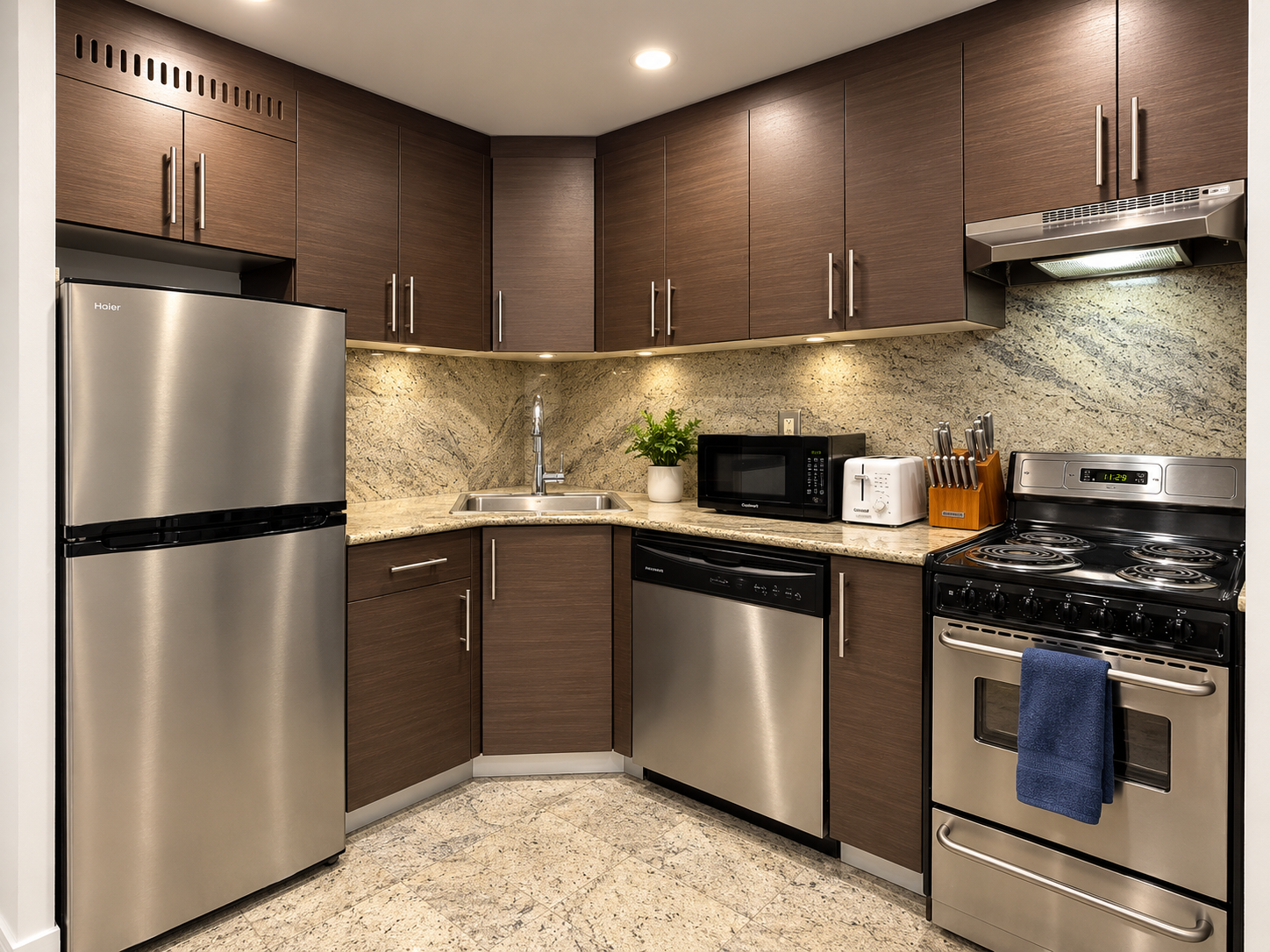 Fully equipped kitchen with stainless steel appliances and gas range — Little Italy NYC 2-bedroom vacation rental.