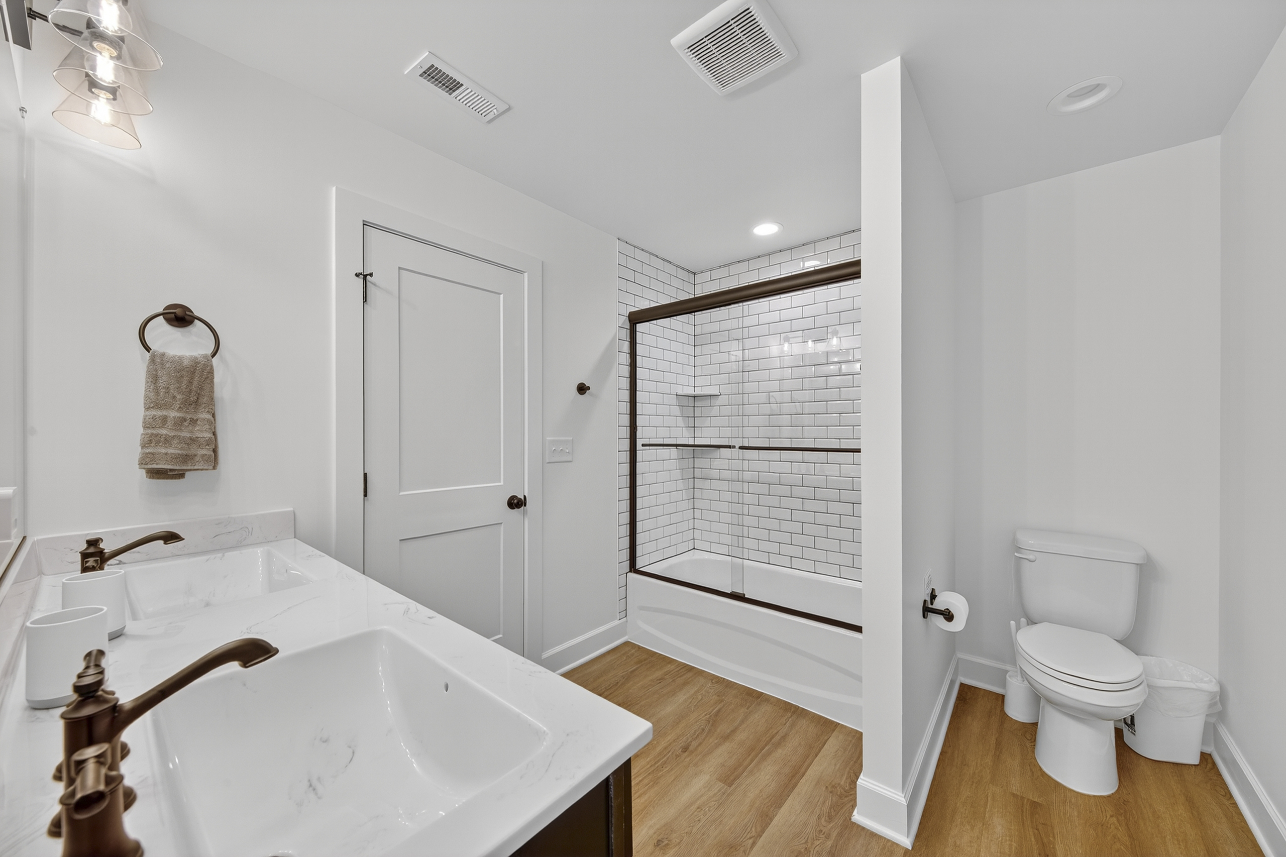 Functional design meets timeless charm in this fresh and bright bathroom, plenty of space for multiple guests.