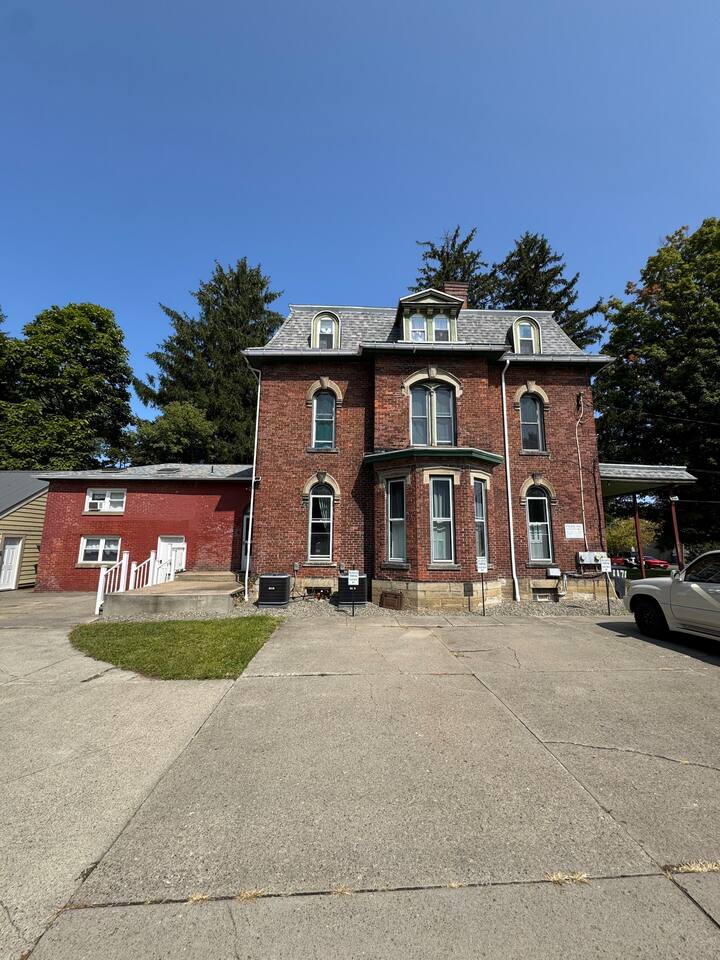 Exterior photo of the building, your space will be located in the add-on to the left of our charming centennial home 