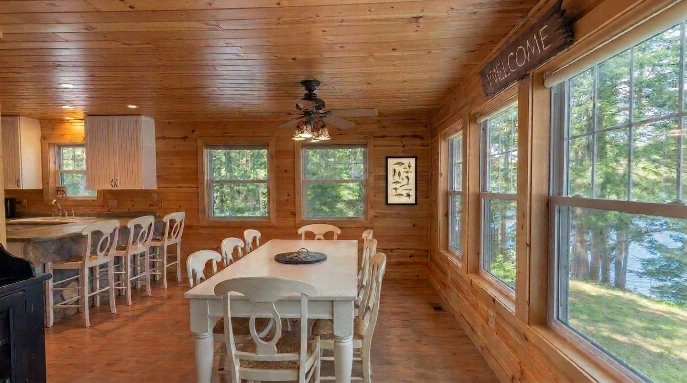 Gather for meals or game nights around the large table with stunning lake views beyond the windows. Spacious, with plenty of room for all!