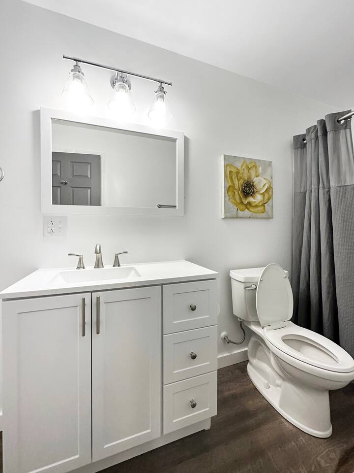 Newly renovated bathroom with shower/tub combo.