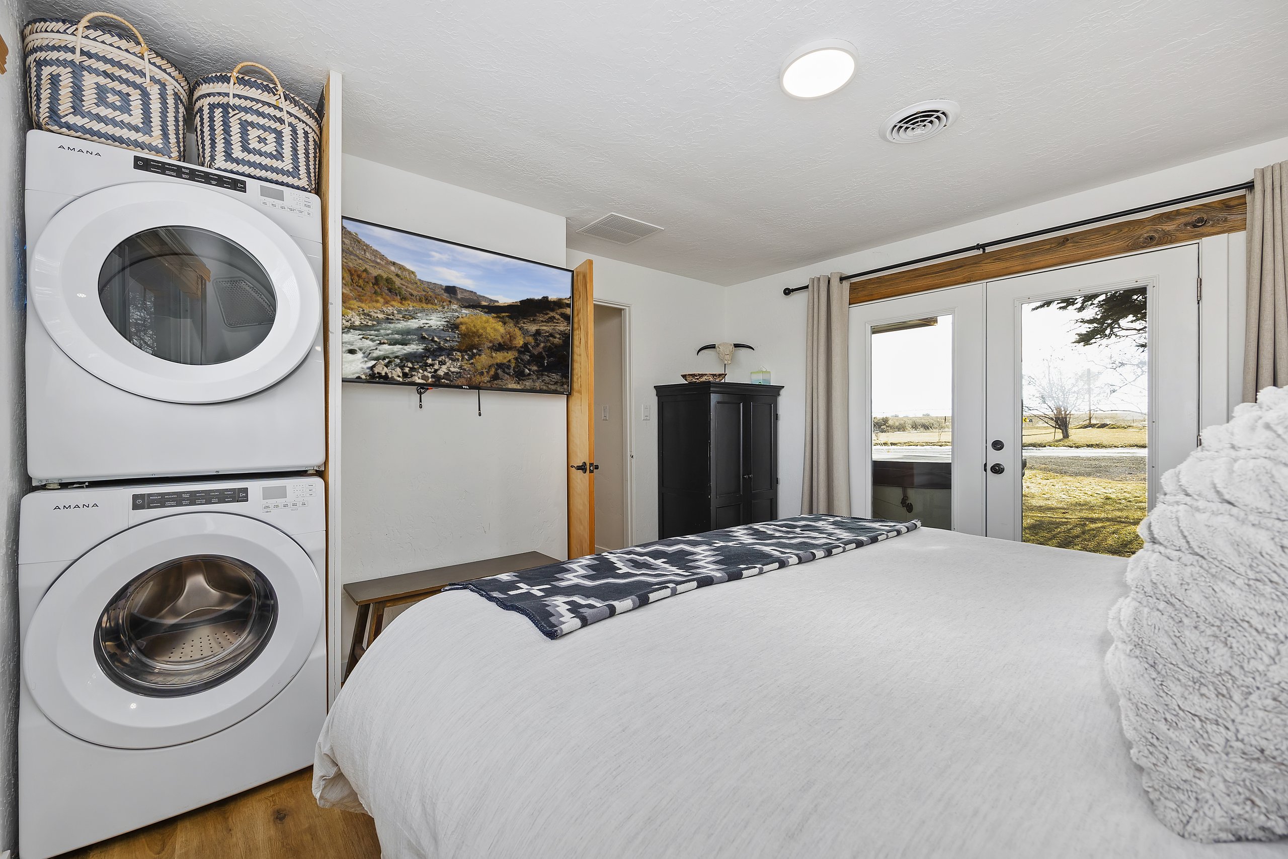 King bedroom with an in-room stacked washer and dryer for easy longer stays