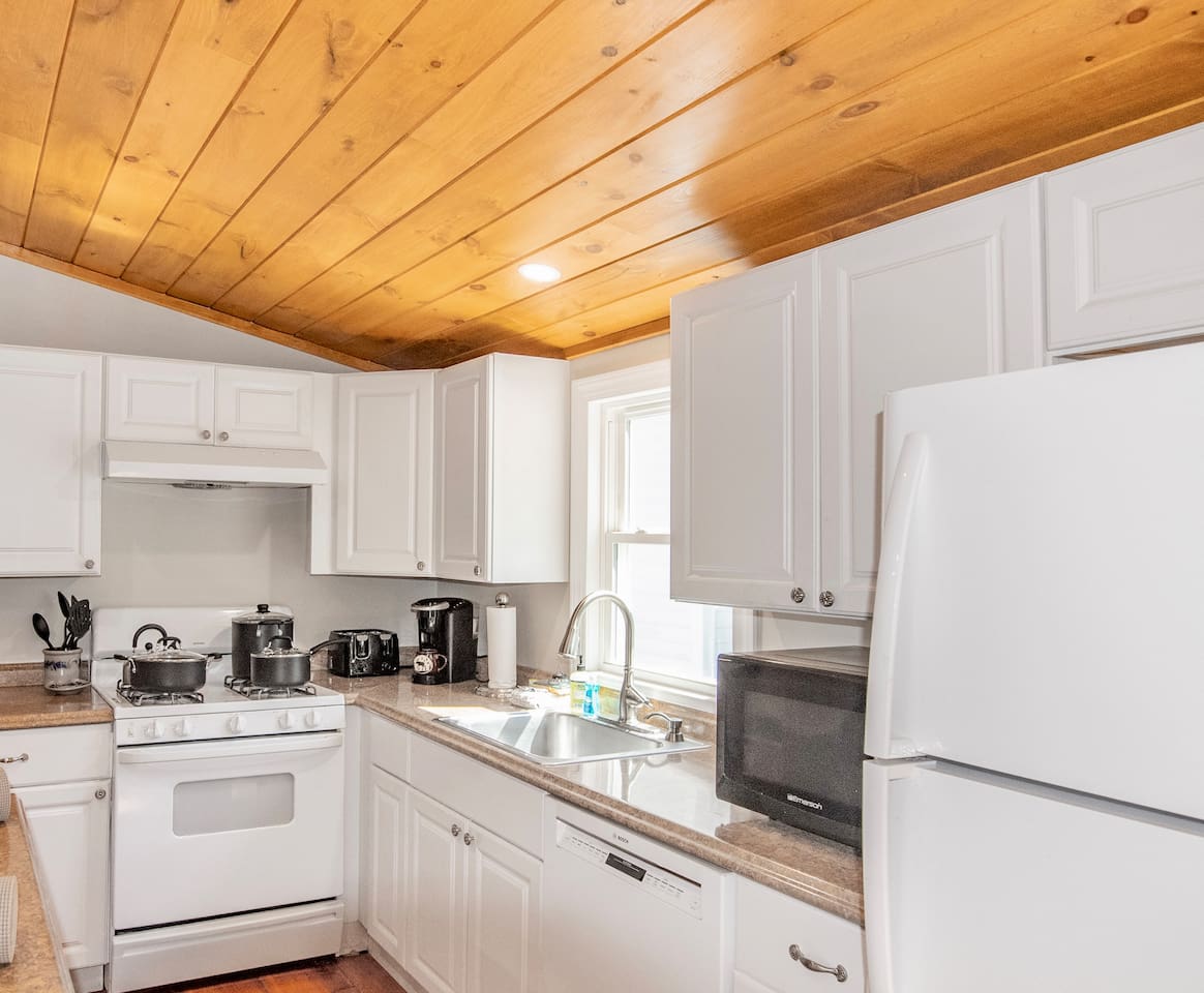 Fully stocked kitchen overlooking living room and dining room 