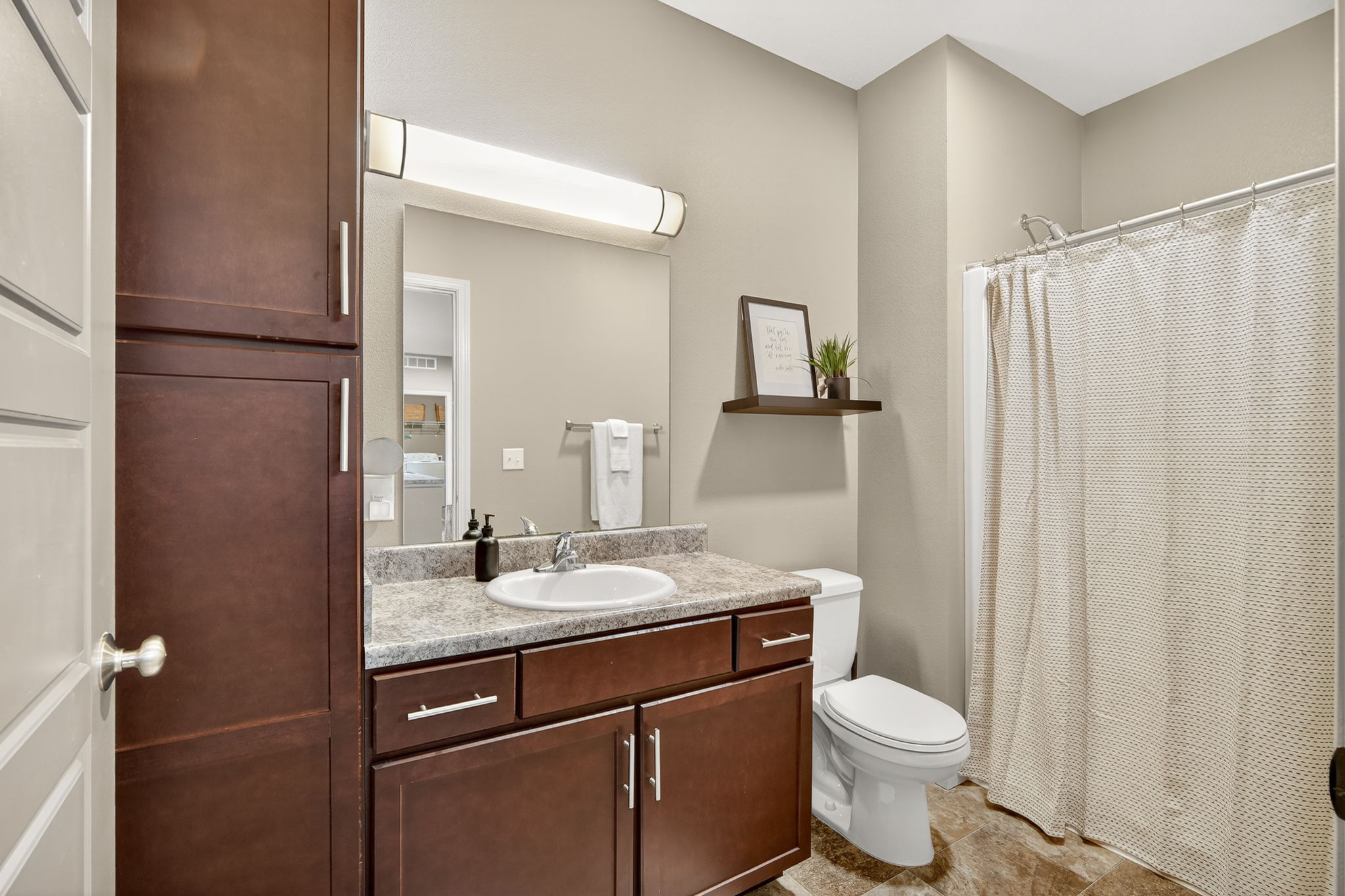The main bathroom is complete with shower and extra storage space in the vanity.