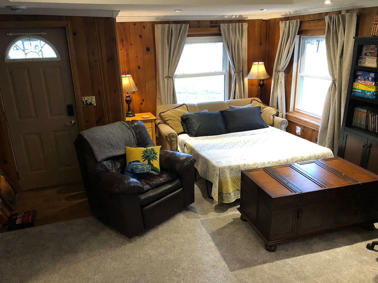 Sofa bed in action! Extra pillows and linens are stored in chest.