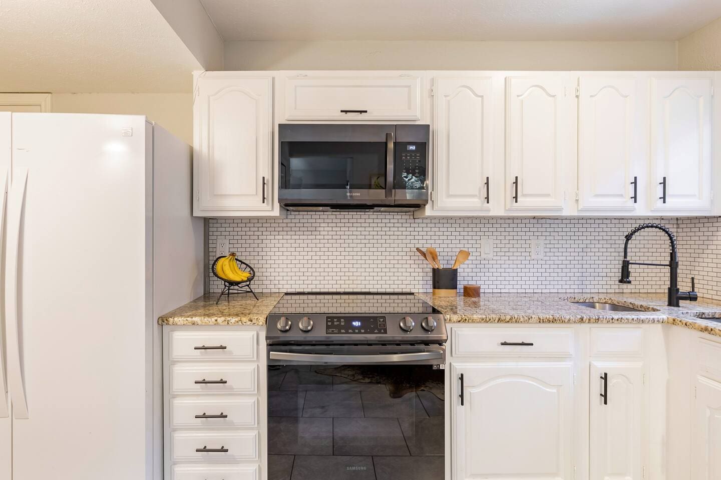 26. Spacious kitchen with stainless steel appliances and ample storage.