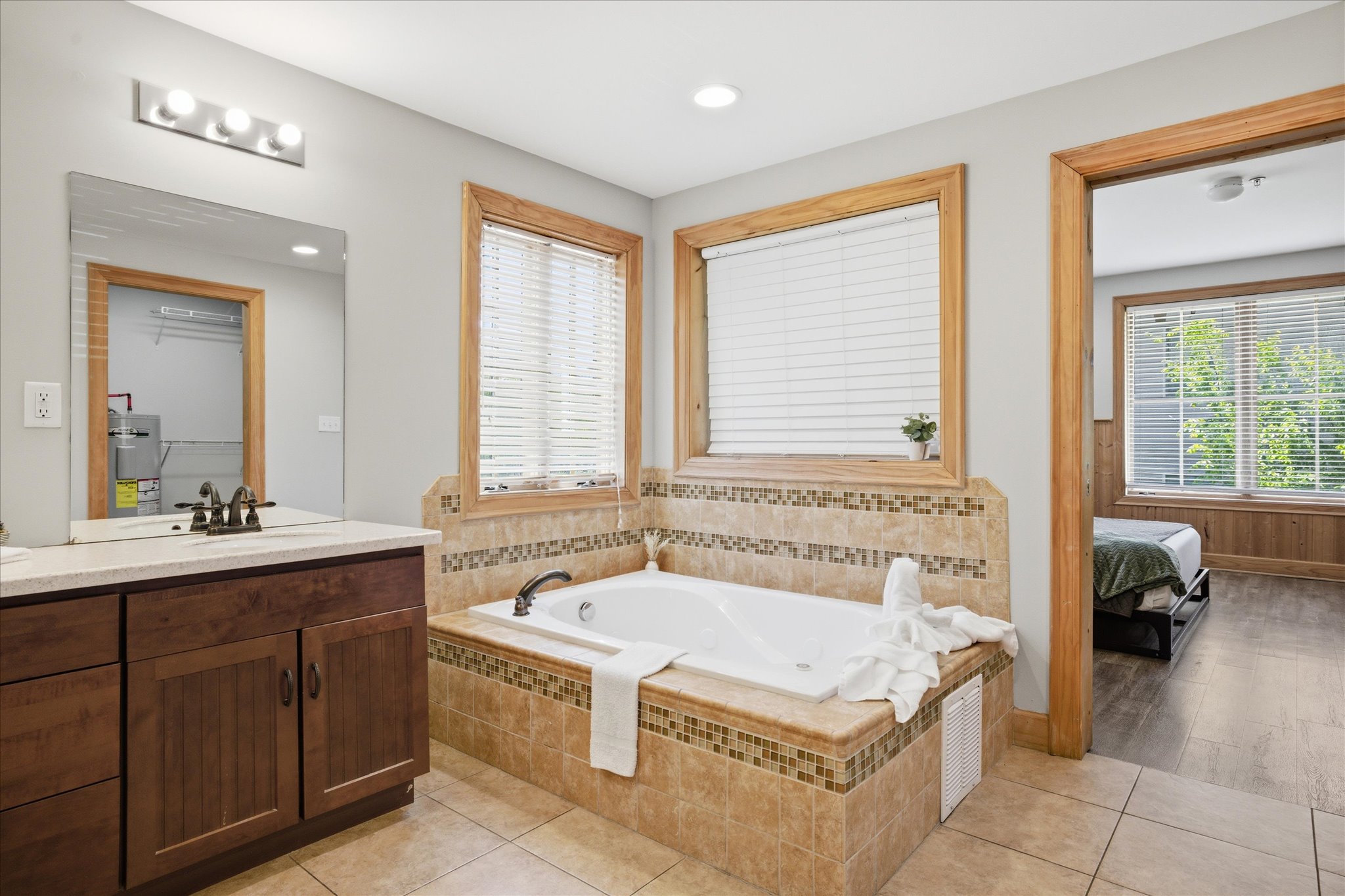 Step into the master bathroom and enjoy a space that feels open, clean, and thoughtfully designed for both getting ready and unwinding at your own pace. With double sinks, a walk-in shower, and soaking tub, you'll find peace here easily.