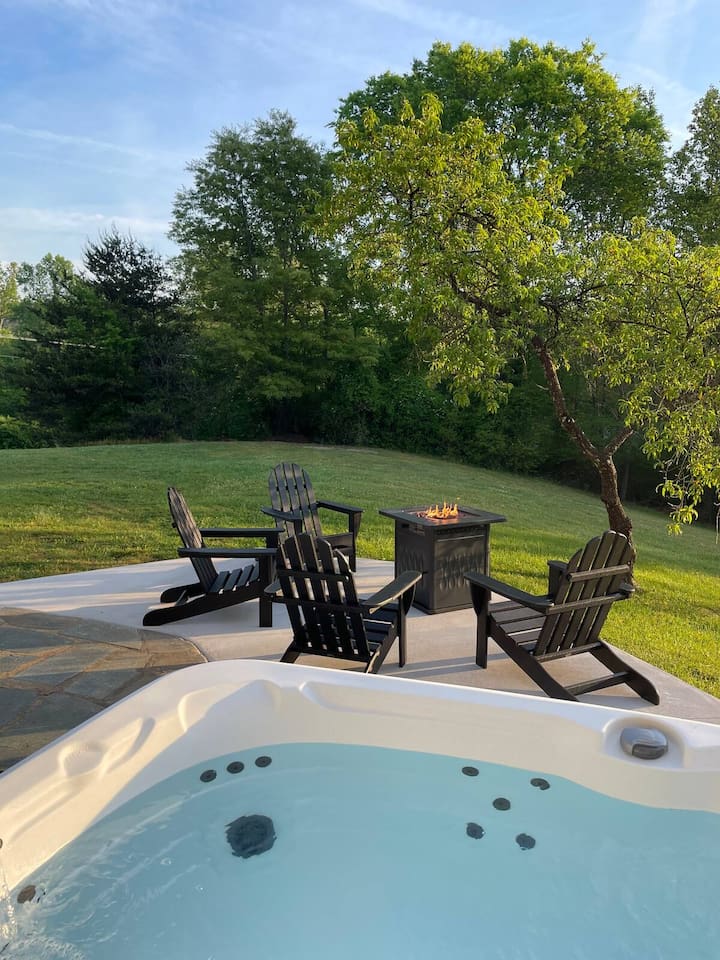 Hot tub, dining, and fire pit on the back patio is shared with any other guests staying on the property.
