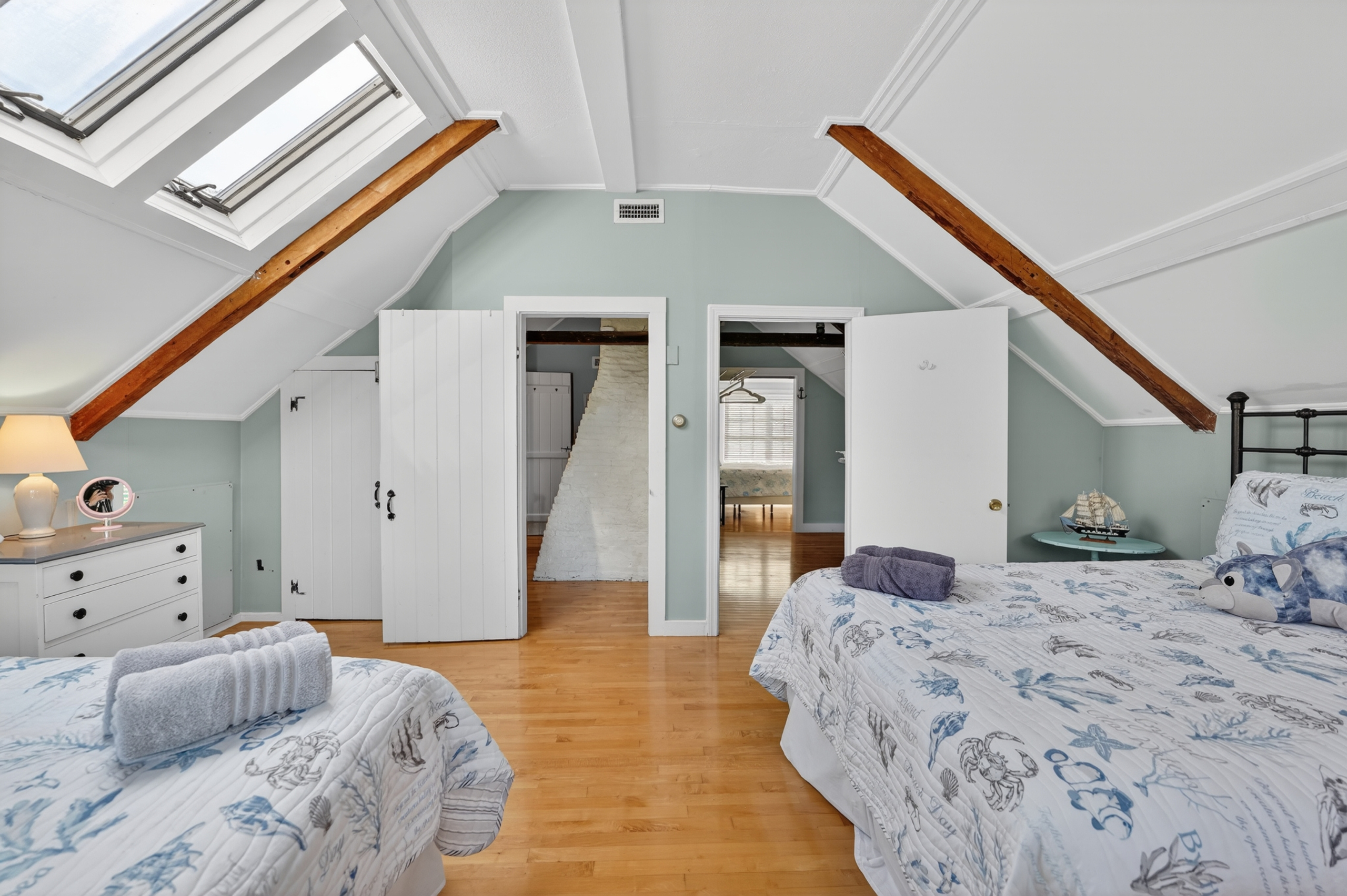 Open loft-style sleeping area with vaulted ceilings, skylights, and plenty of room for everyone to relax.