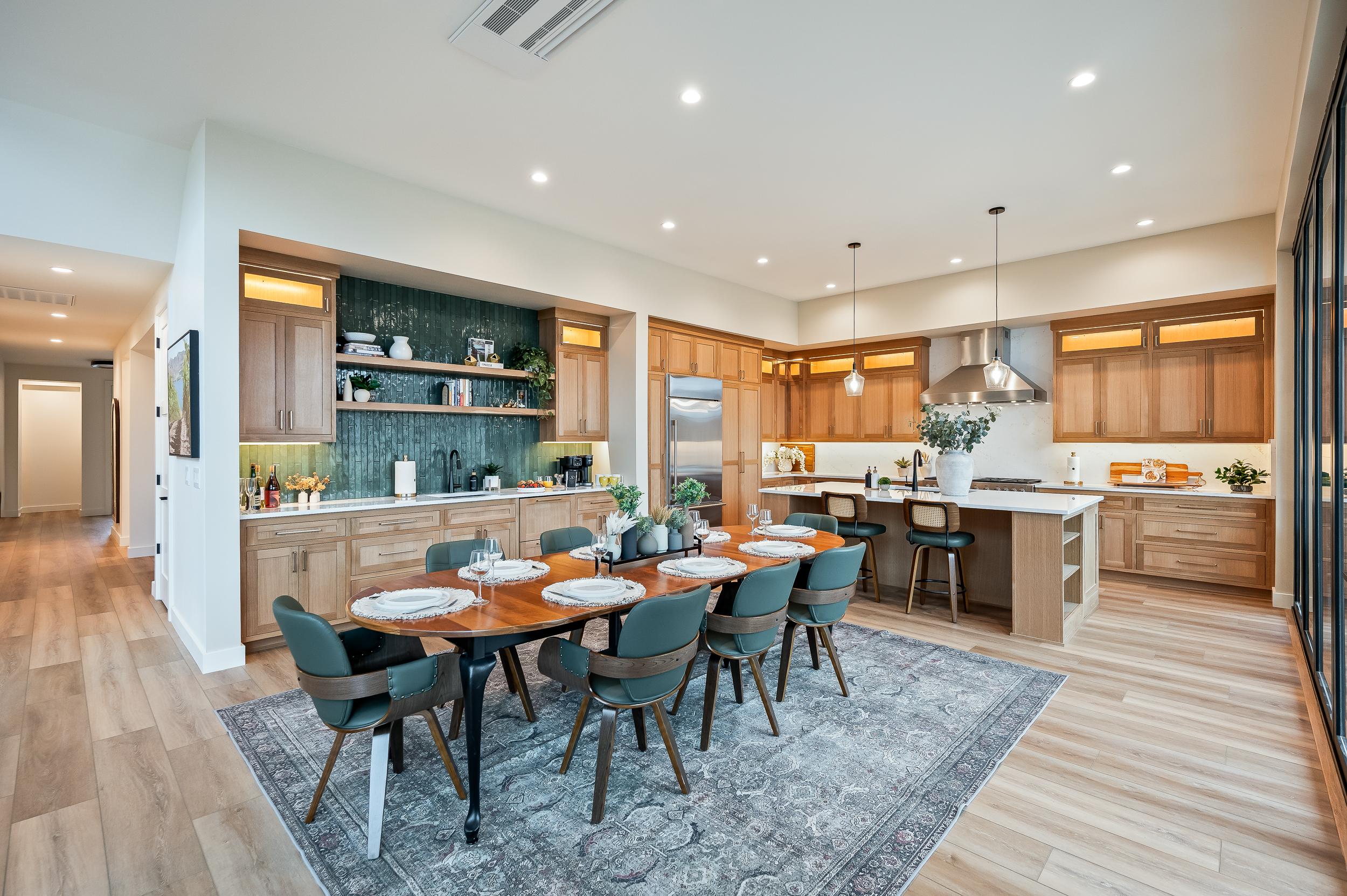 Dining table can seat up to 12, with 2 seats at the kitchen island. Wet bar has two pull-out refrigerator drawers.  