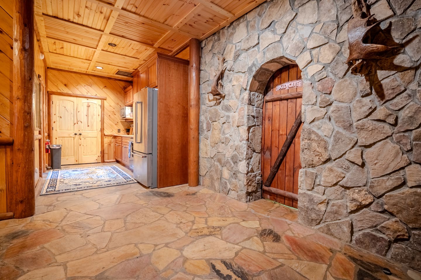 Bottom floor hallway with kids' cave and kitchen