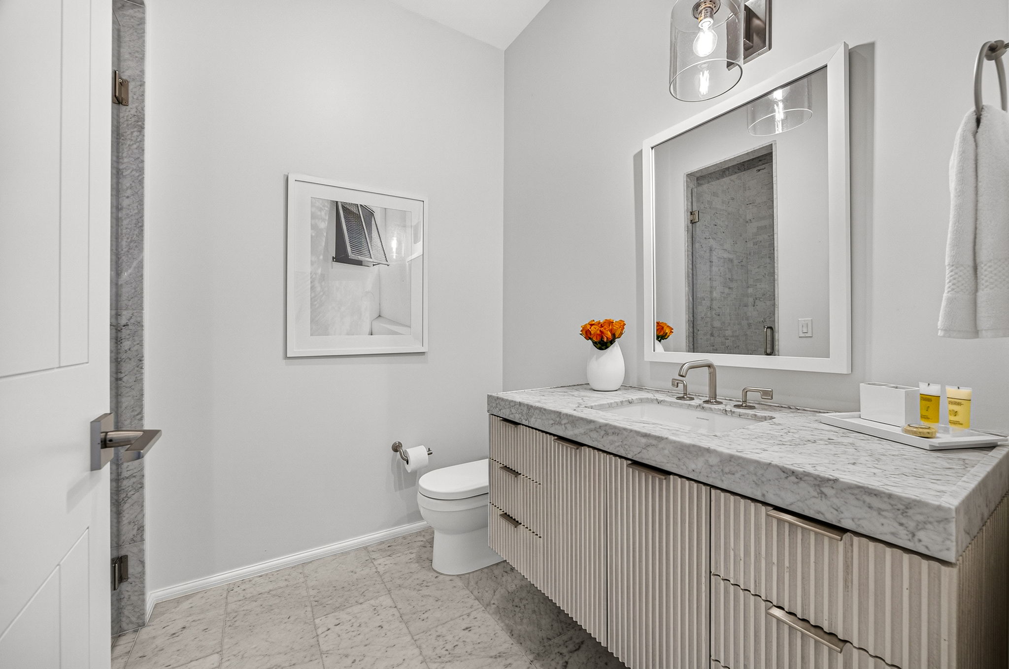 Guest Suite #2 ensuite bath offers an oversized vanity and walk-in shower.