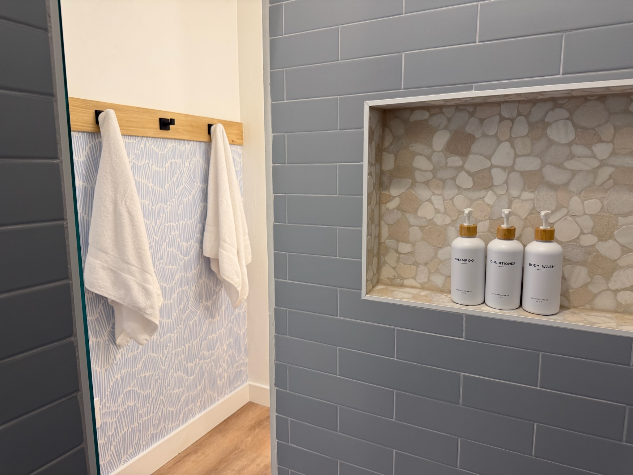Beautifully tiled seamless walk-in shower located in bunk room suite