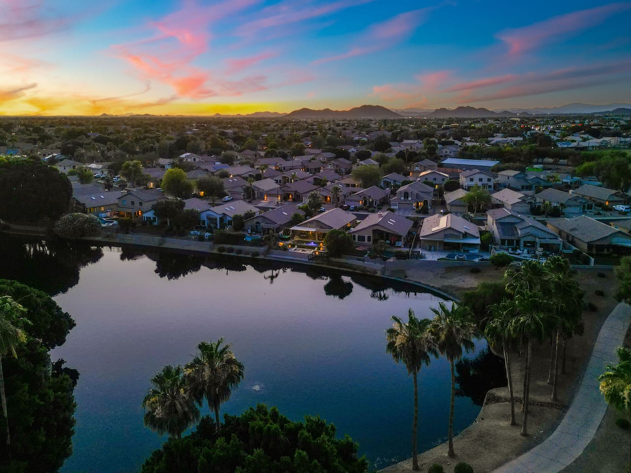 Your backyard sits along a quiet, palm-lined lake that reflects the sunset perfectly — a peaceful backdrop you can enjoy from the patio or the water's edge.