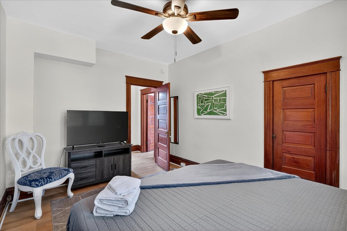 Another angle of the bedroom that features a king-size bed and 50in smart TV.
