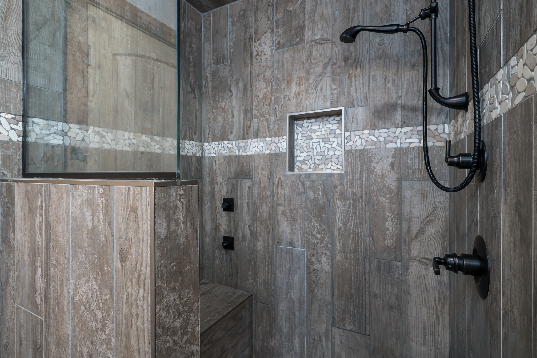 Master shower with bench and 4-way shower spray.
