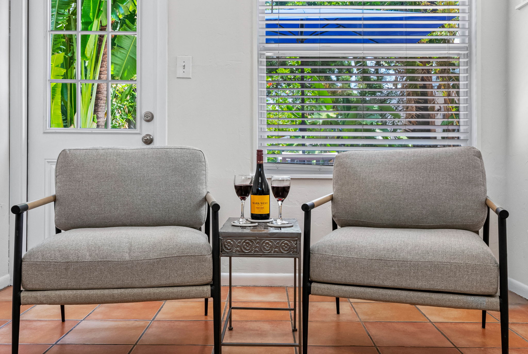 Large windows and light-colored walls flood the room with natural light, creating a fresh, open ambiance throughout the day.