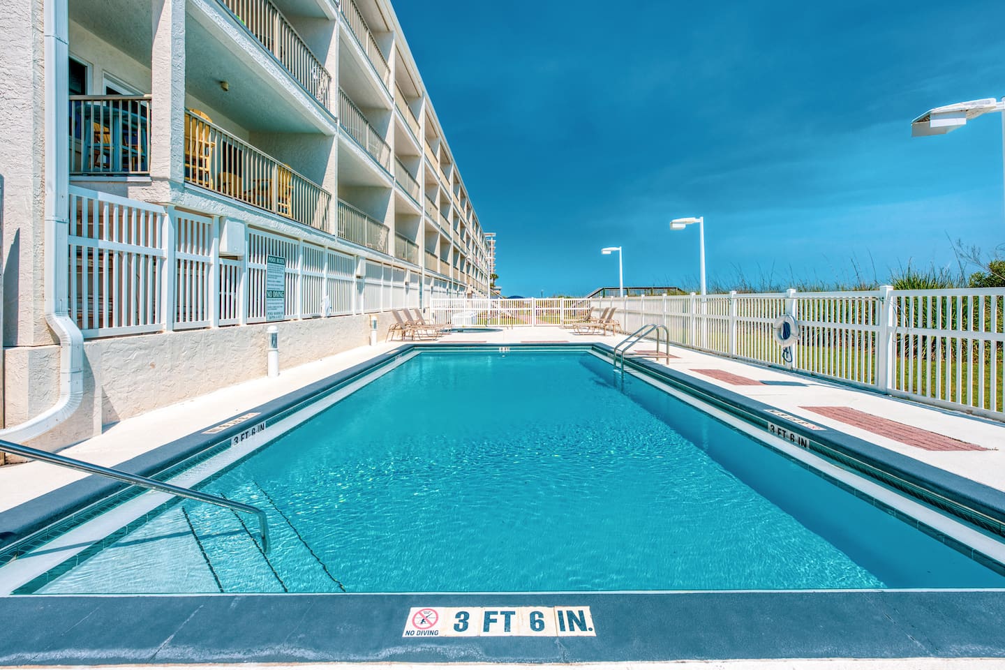 Shared outdoor heated pool for a refreshing break from the beach.