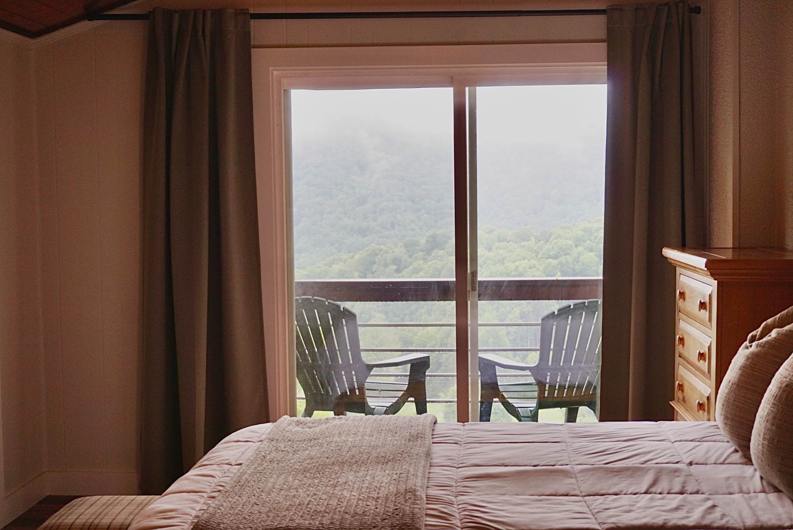Unwind and escape. This bedroom offers a tranquil retreat with breathtaking views and private balcony access.