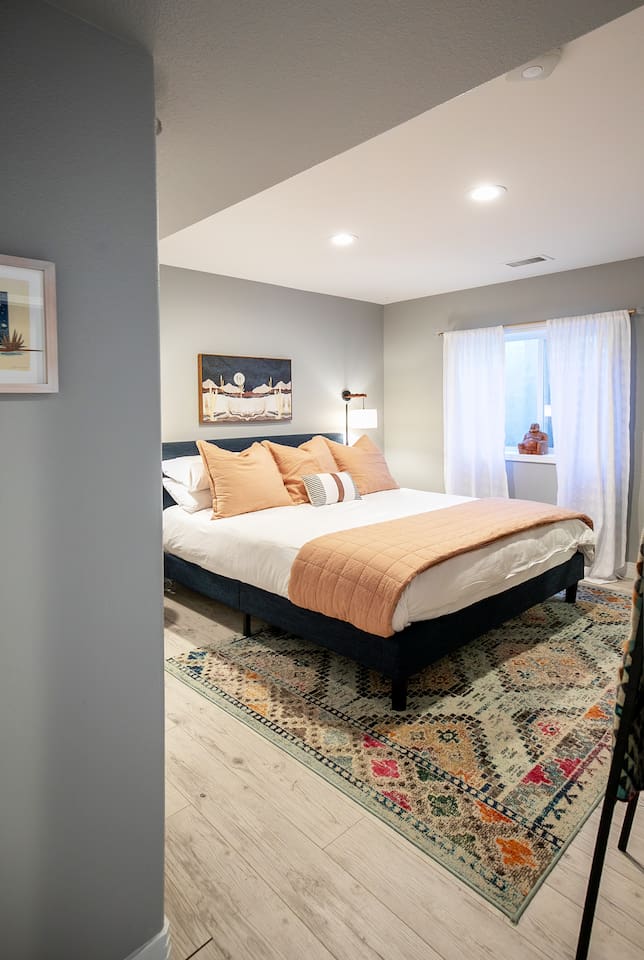 Comfortable king bedroom with modern finishes and calming tones, perfect for relaxing after a fun-filled day outside adventuring.