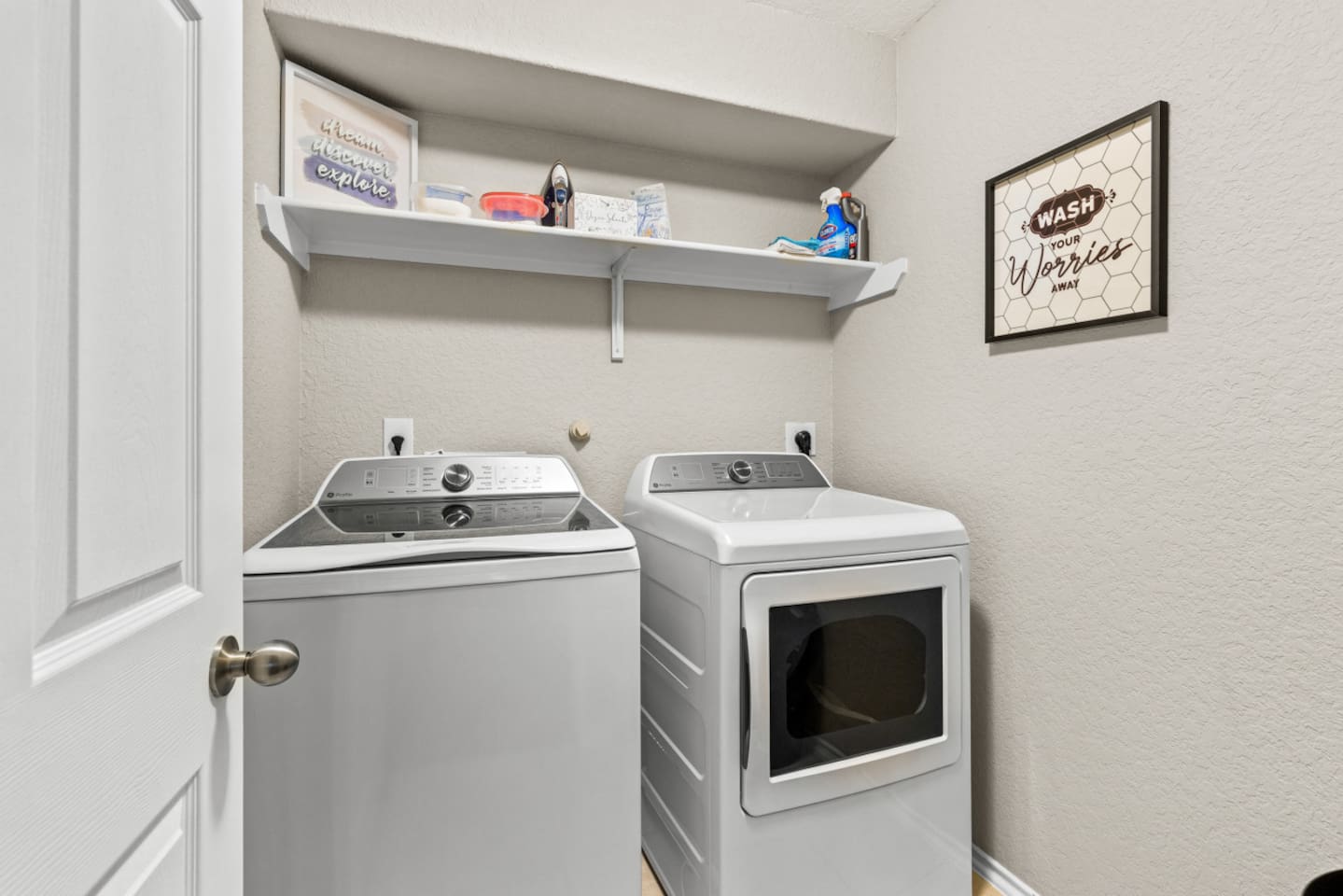 Utility room with washer, dryer, and storage shelving—perfect for families and extended visits.