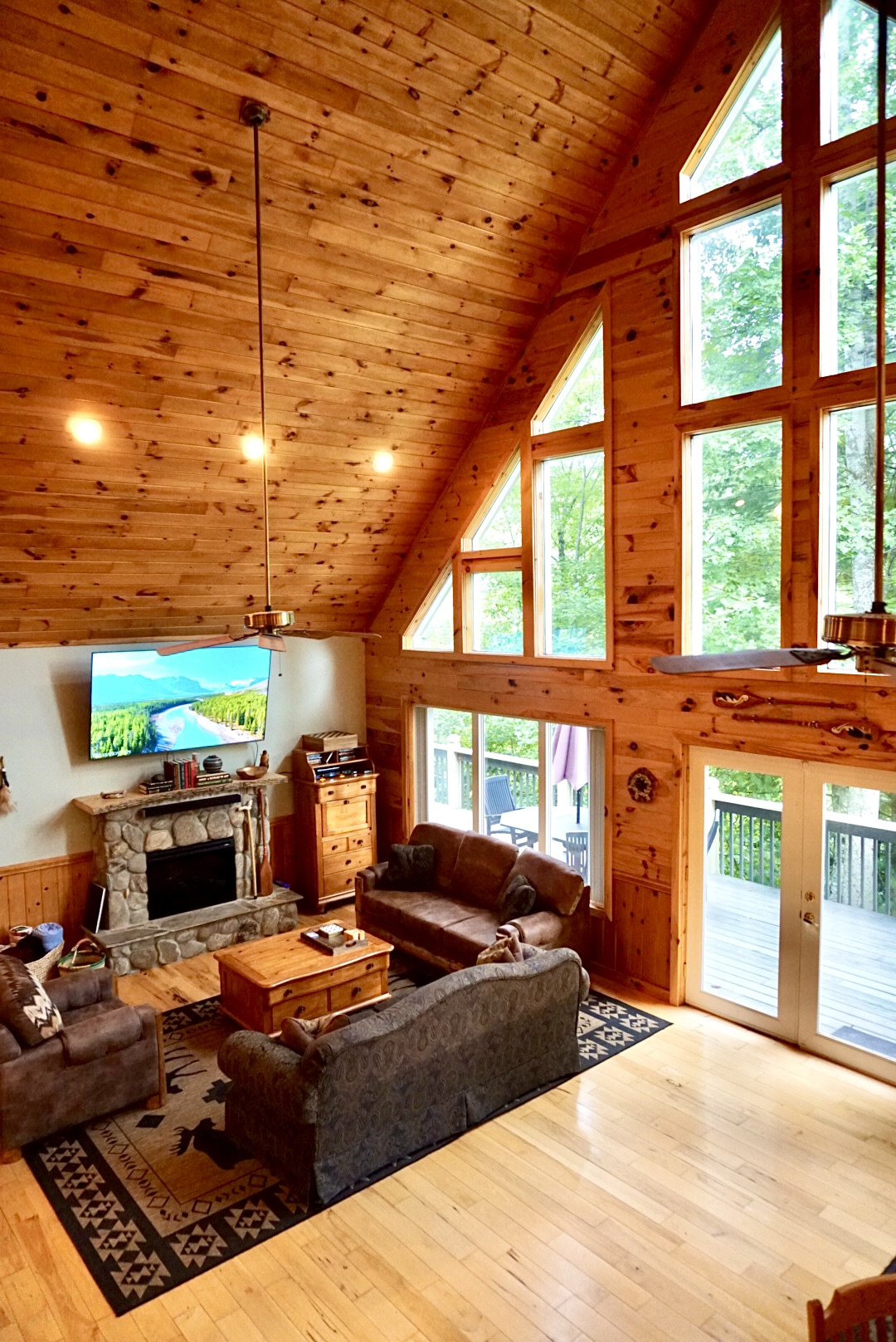 Living Room: Experience nature's beauty through expansive windows in this inviting retreat!