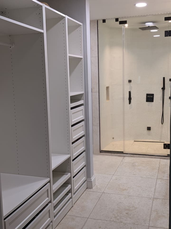 Here is a view of the other side of the closet system with a peak of the primary bath shower. 