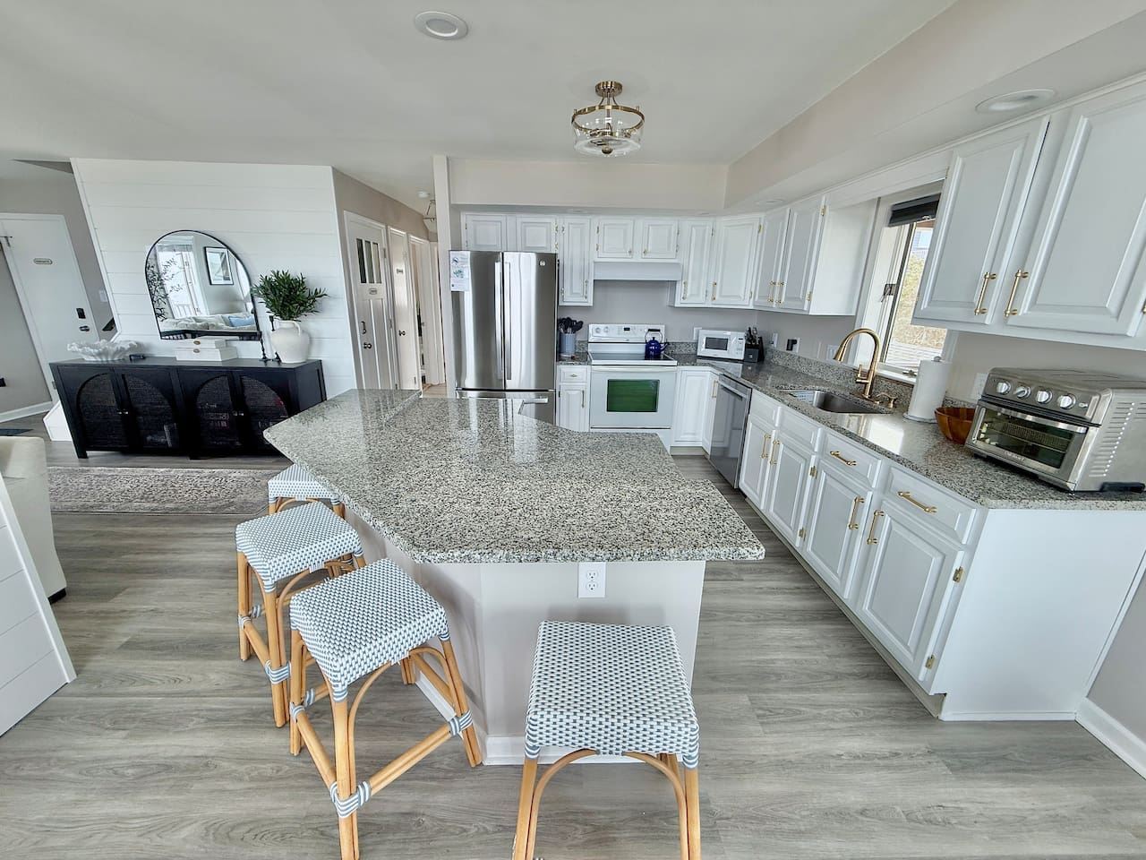 Enjoy the convenience of this bright, modern kitchen. With ample counter space and stylish seating, it is the perfect spot for friends and family to gather, chat, and relax together during your dream coastal getaway.