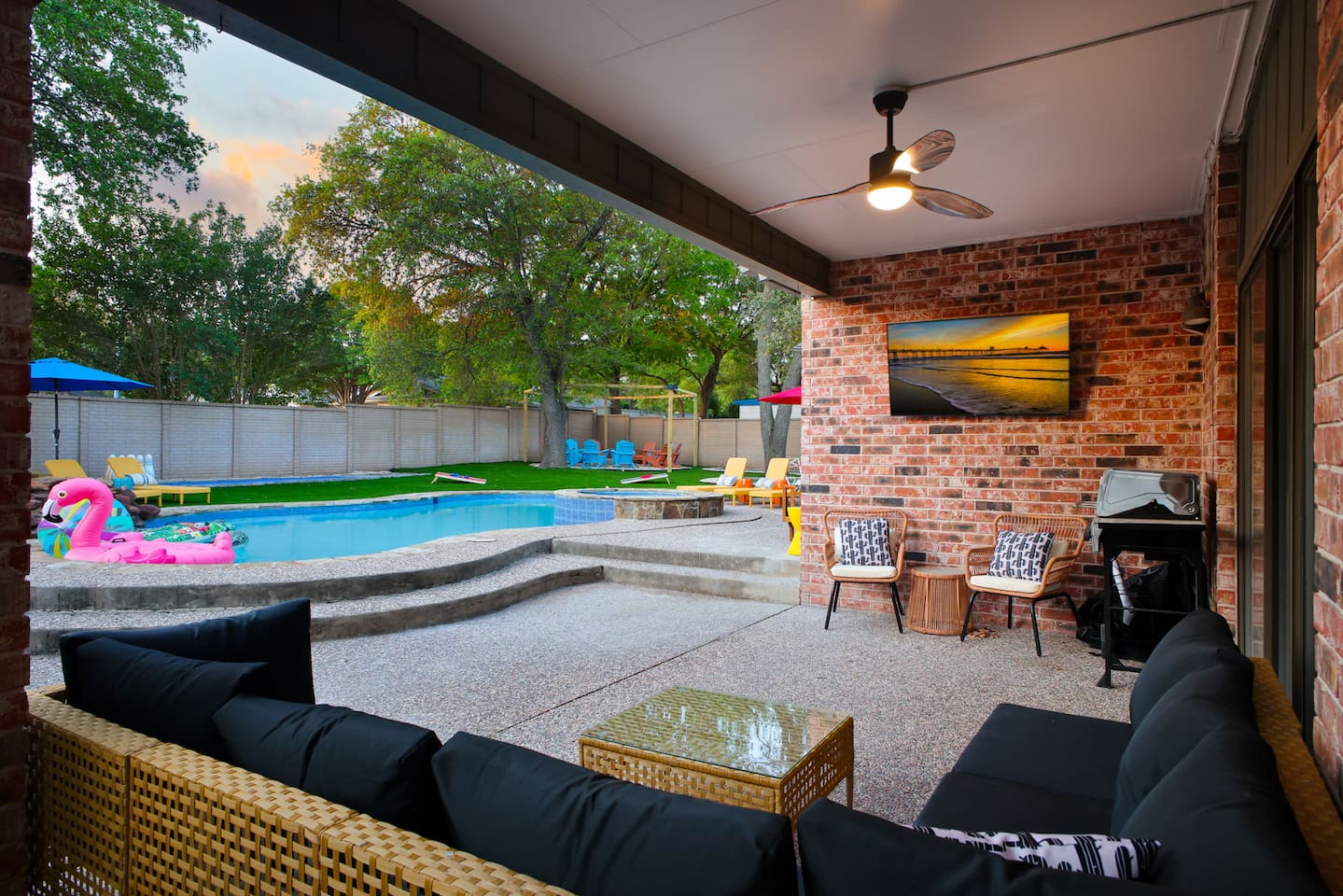  Shaded seating, ceiling fans, and an outdoor TV for poolside movie nights.