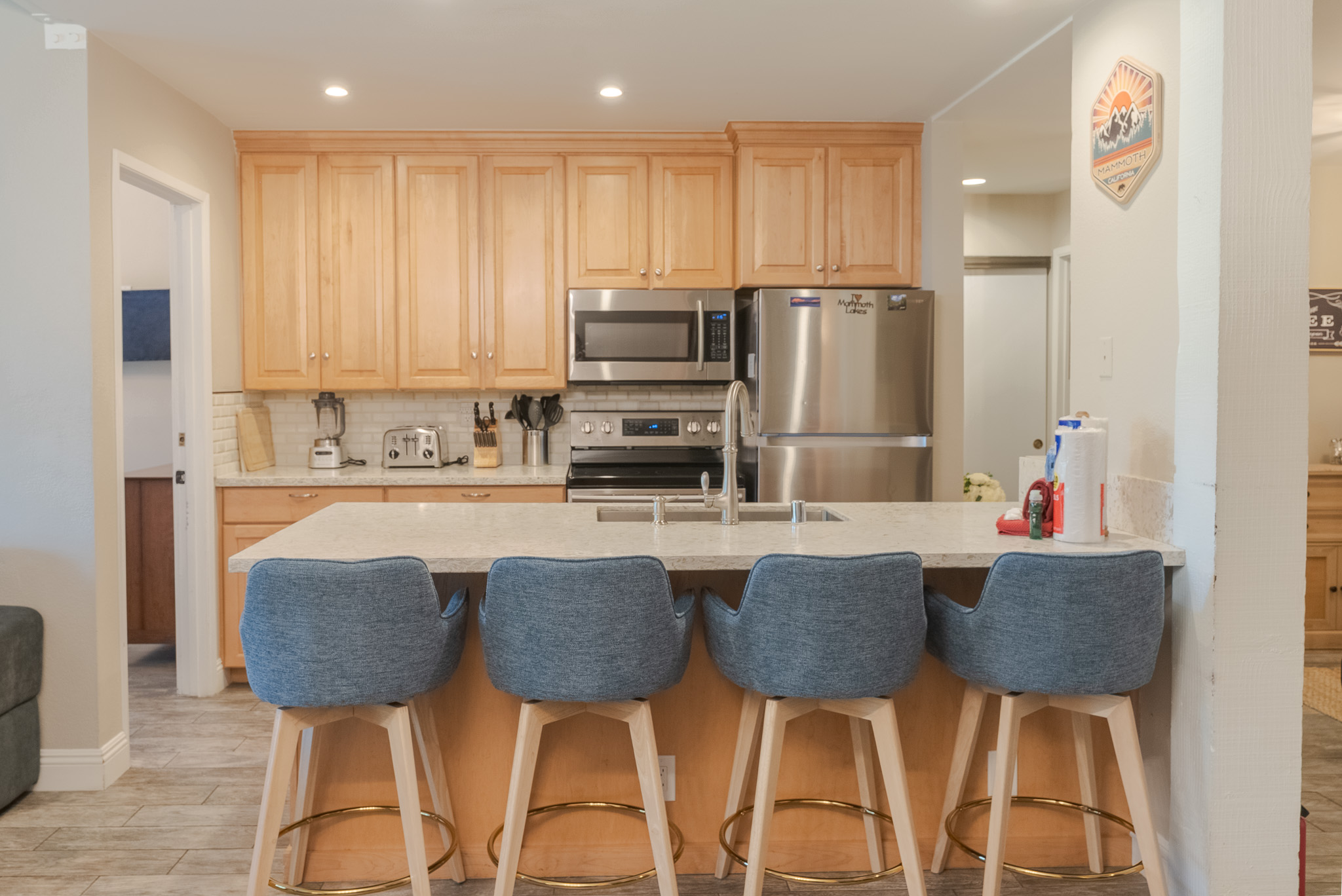 Fully loaded kitchen with seating for four at the counter.