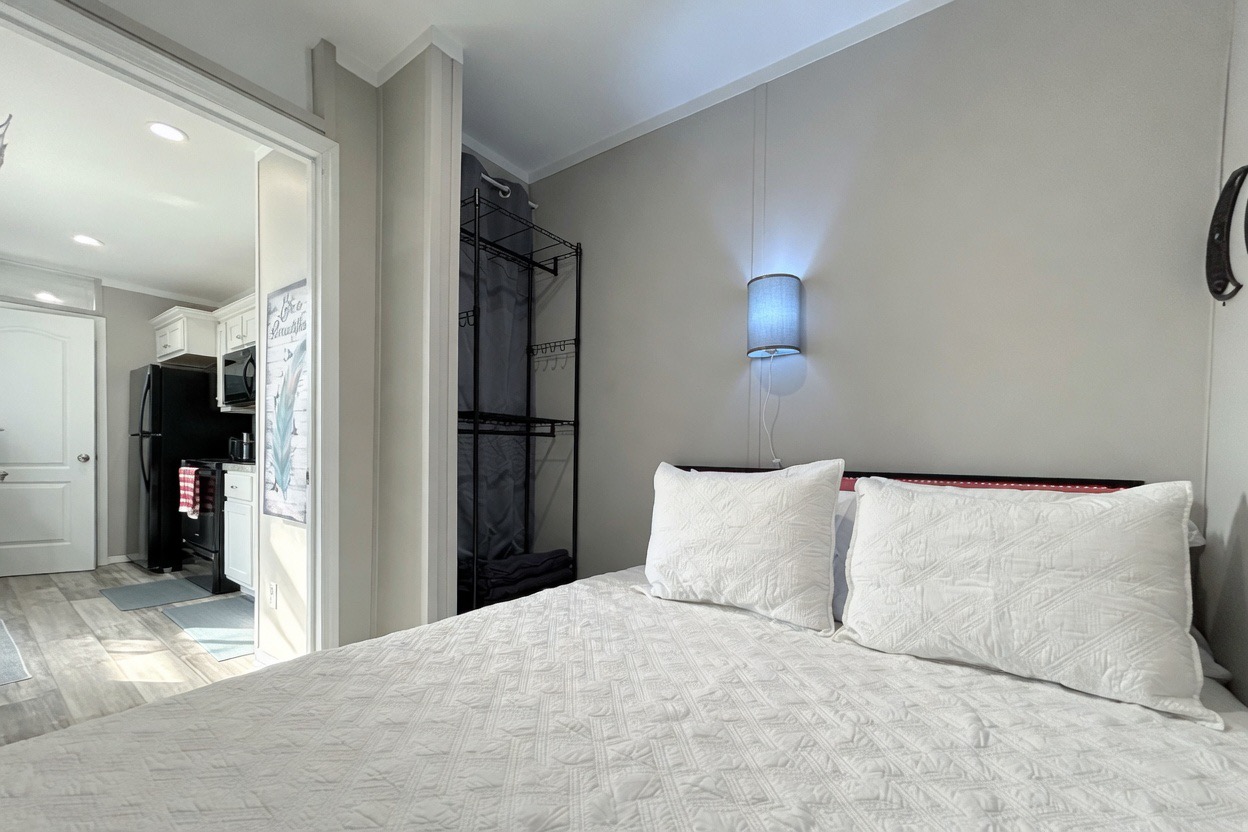 Bedroom #1 with queen bed, smart TV, en-suite bathroom & hidden washer/dryer combo