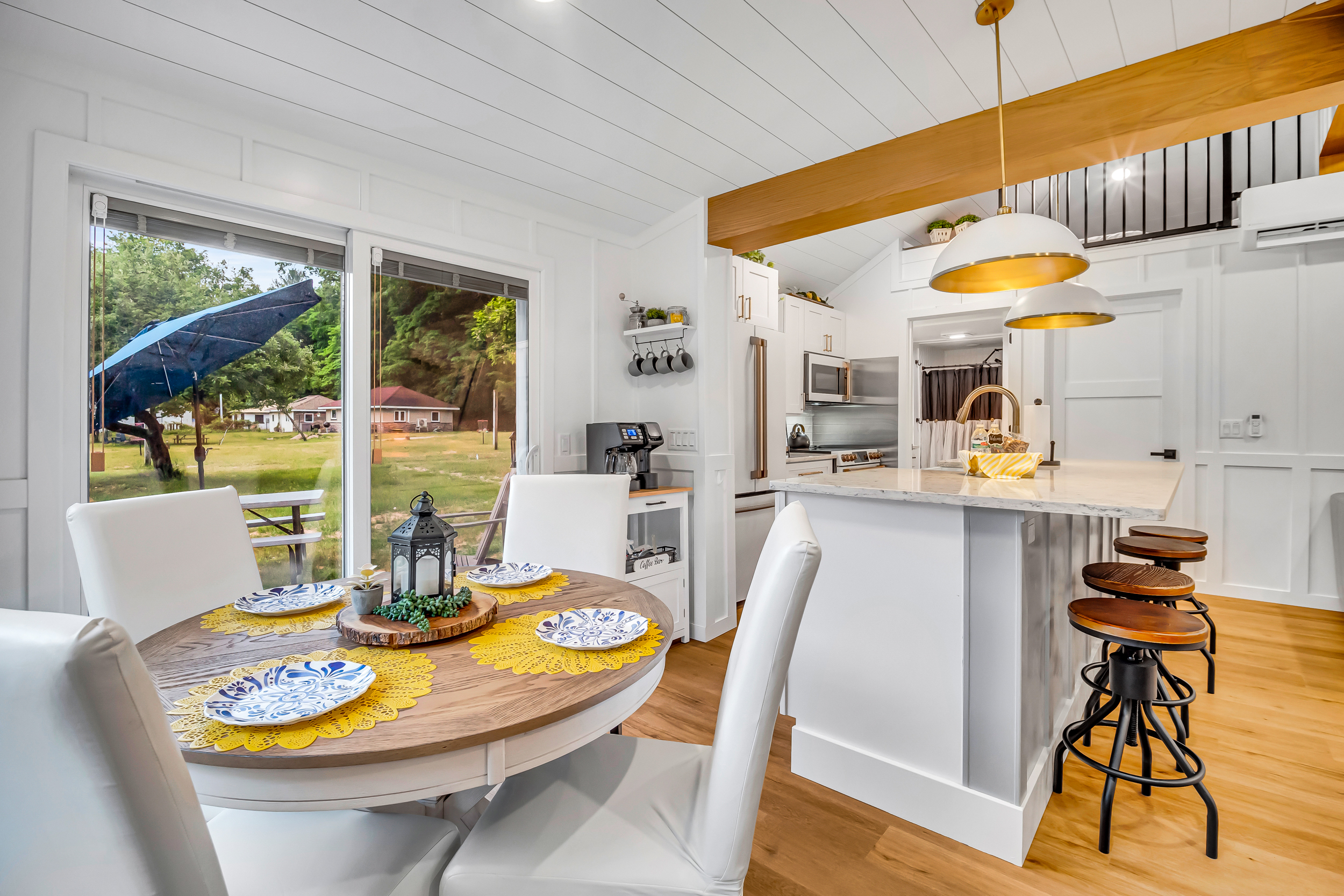Fully appointed kitchen has everything you need to prepare meals. Just steps to the kitchen table, large island counter or out the side slider to the waiting picnic table and large poly wood chairs.