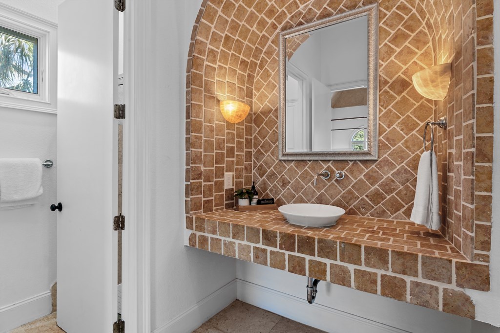 Architectural bath with custom tile and arched design