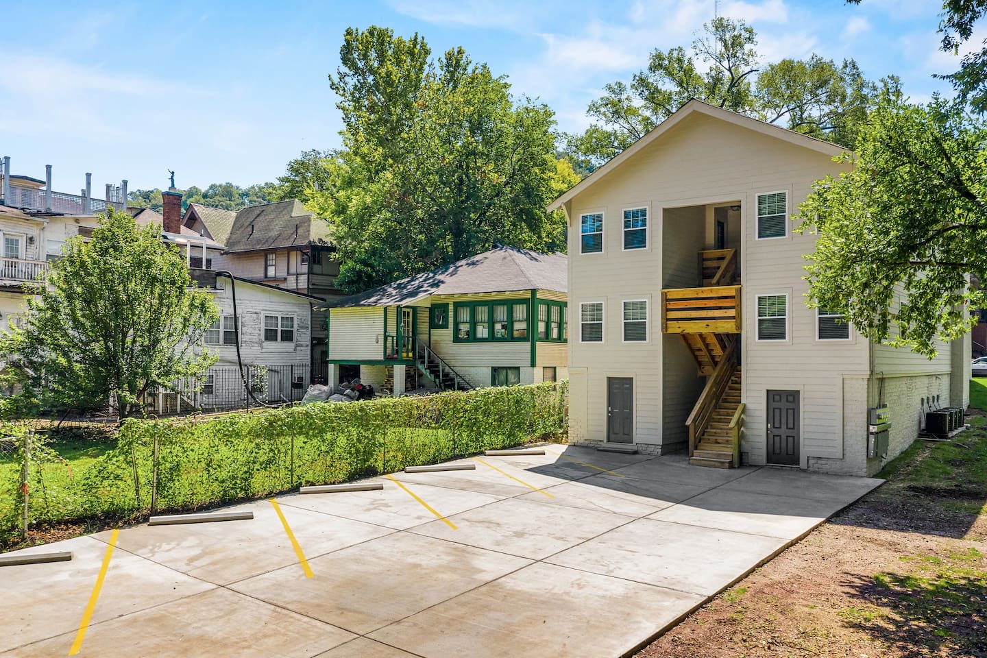 The back of Avenue Quads, showing additional outdoor spaces for parking and the building's elegant design.
