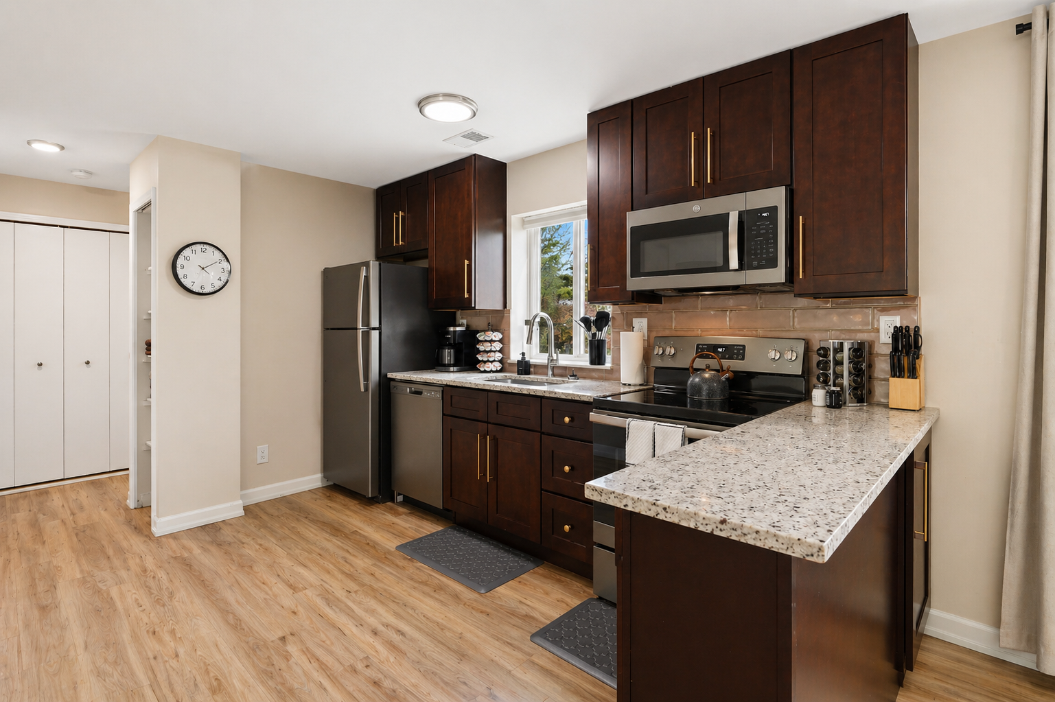 Modern kitchen with sleek black appliances, complete with a Keurig coffee maker.