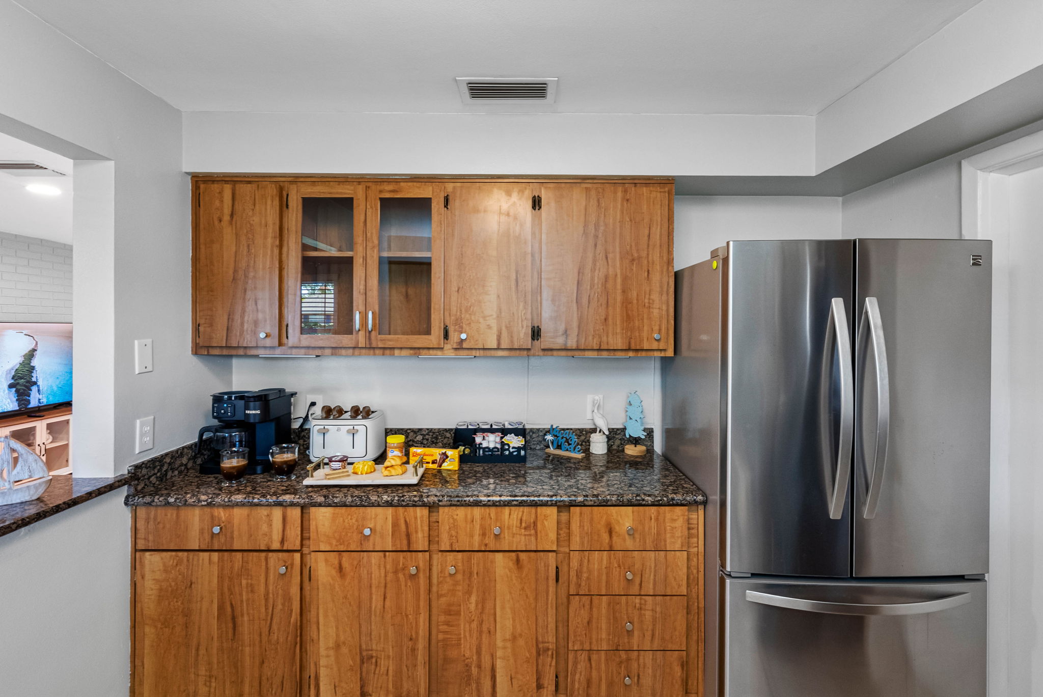 Warm wood cabinetry meets modern convenience in this stylish and functional kitchen.